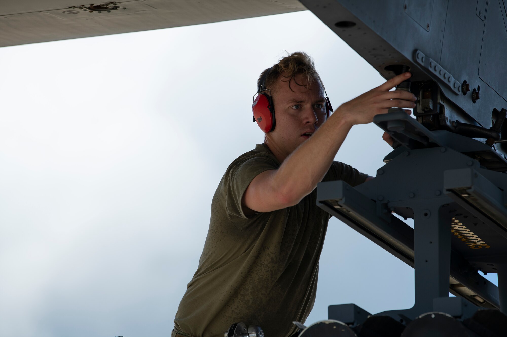 U.S. Air Force Staff Sgt. Matthew Holcomb, 73rd Aircraft Maintenance Unit weapons load crew chief, secures AGM-114 Hellfire missiles to an AC-130 Whiskey training aircraft simulating an AC-130J Ghostrider during a quarterly load crew competition at Hurlburt Field, Florida, July 8, 2022.