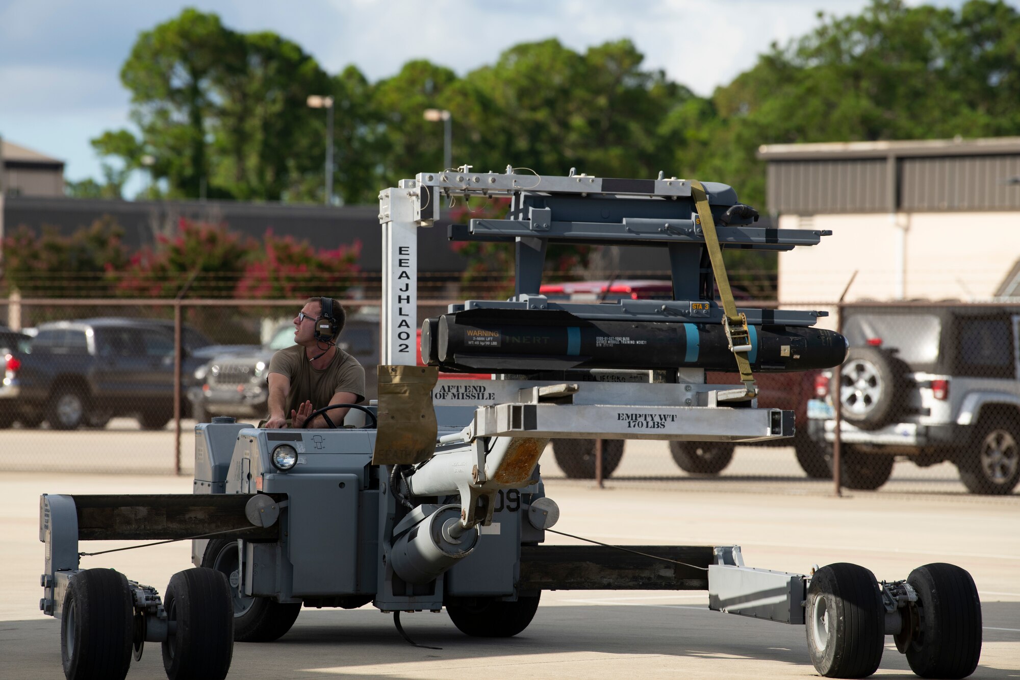 U.S. Air Force Senior Airman Jordan Stout, a 73rd Aircraft Maintenance Unit weapons load crew member, transports two AGM-114 Hellfire missiles during a quarterly load crew competition at Hurlburt Field, Florida, July 8, 2022.