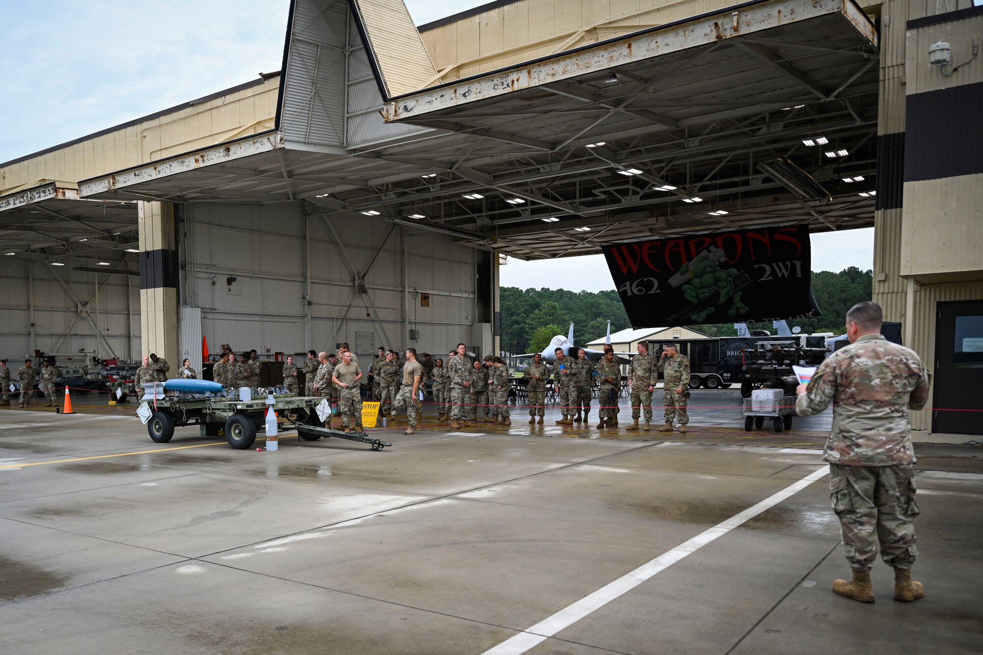 Airmen assigned to the 4th Fighter Wing attend a quarterly load crew competition at Seymour Johnson Air Force Base, North Carolina, July 15, 2022. Participants of the competition were judged on their accuracy, serviceability, and efficiency of loading weapons onto an F-15E Strike Eagle. (U.S. Air Force photo by Senior Airman David Lynn)