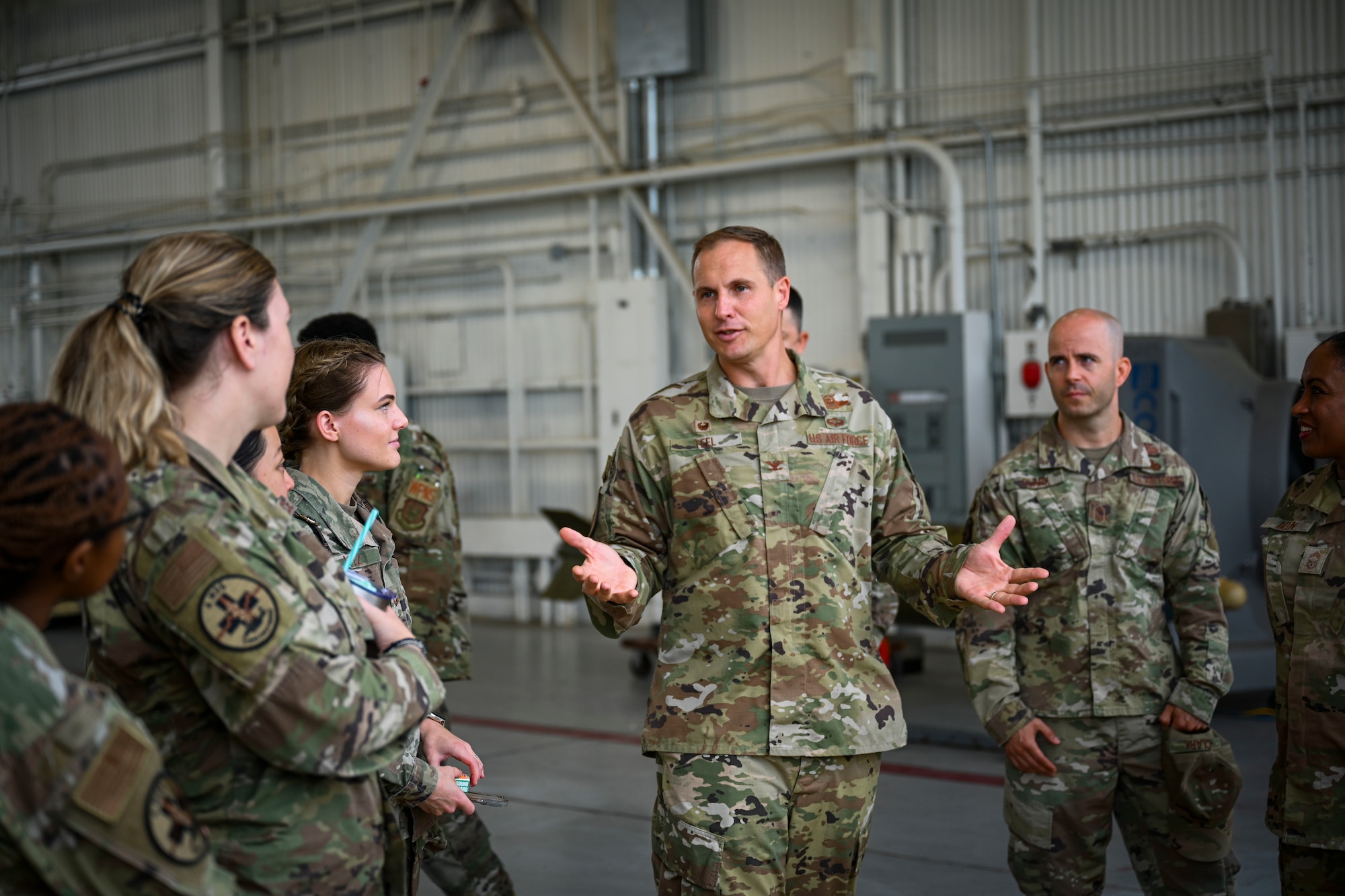 Col. Lucas Teel, second from right, 4th Fighter Wing commander, talks to Airmen at a quarterly load crew competition at Seymour Johnson Air Force Base, North Carolina, July 15, 2022. The competition was held to build morale and test the load crews loading capabilities. (U.S. Air Force photo by Senior Airman David Lynn)