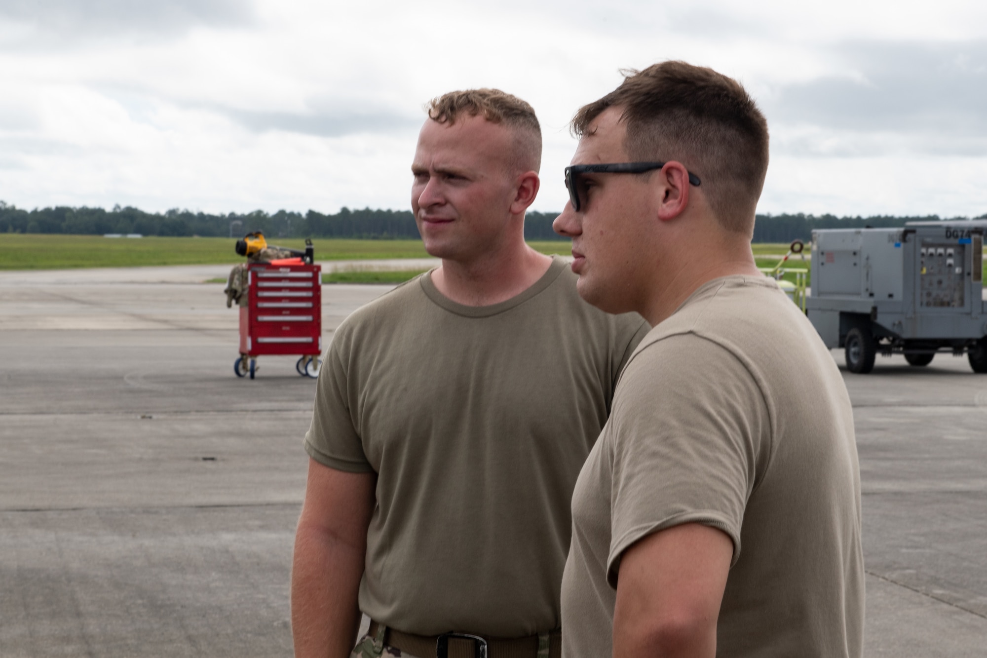 U.S. Air Force Staff Sgt. Nicholas Spangler, 71st Rescue Generation Squadron dedicated crew chief, and Senior Airman Clark Ivey, 71st RGS assistant dedicated crew chief, await the take-off of the Black Letter flight on July 12, 2022, at Moody Air Force Base, Georgia. The last documented Black Letter flight at Moody was in 2020 by the 41st Helicopter Maintenance Unit. (U.S. Air Force photo by Staff Sgt. John Crampton)