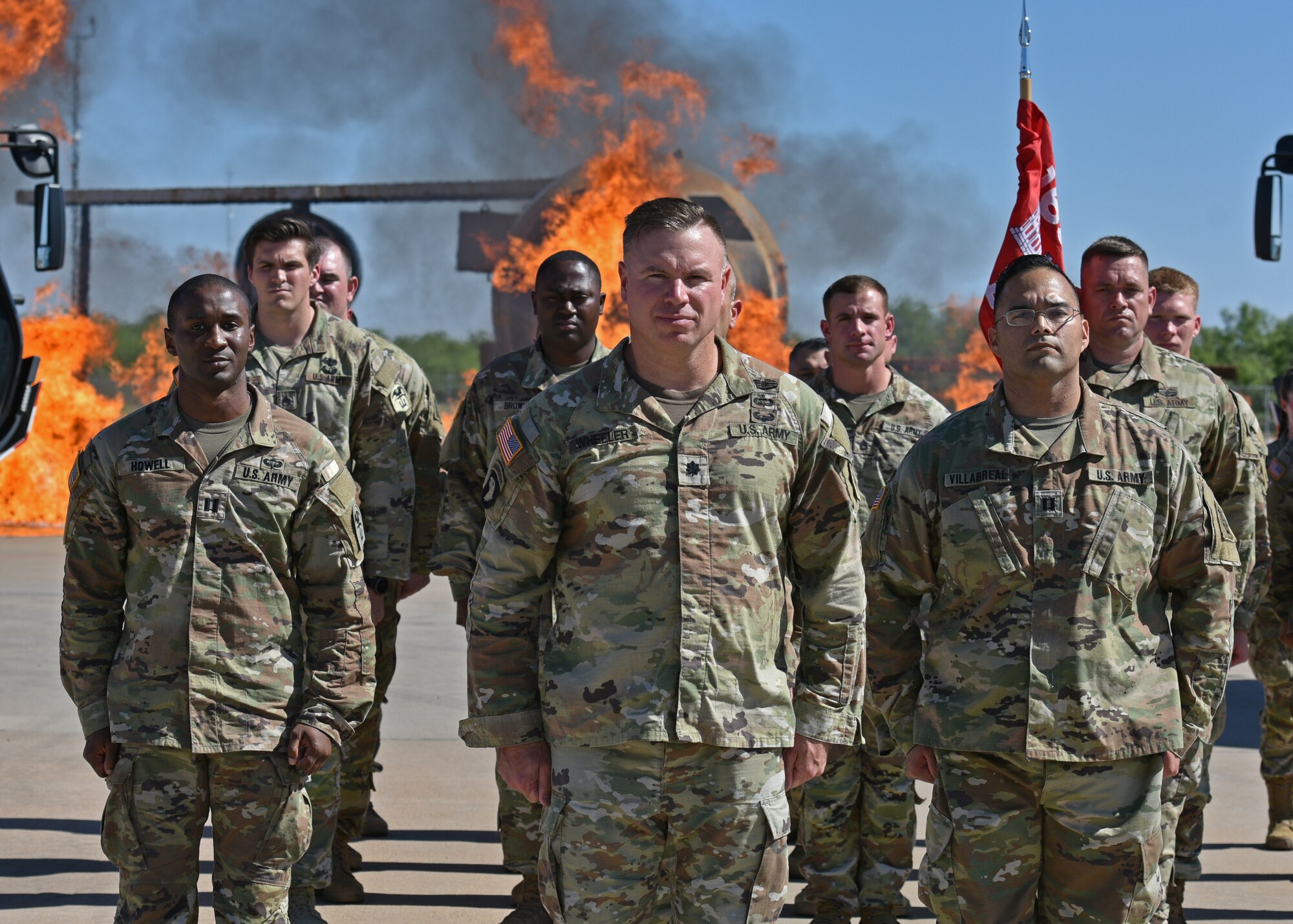 U.S. Army Lt. Col. Jeremy Wheeler, middle, 169th Engineer Battalion commander, Capt. Astin Villarreal, right, outgoing Delta Company 169th EN BN commander, and Capt. Jarred Howell, left, incoming D CO 169th EN BN commander, stand in formation during their change of command at Goodfellow Air Force Base, Texas, July 15, 2022. The 169th EN BN contributes instructors and students to the mission held at the Louis F. Garland Department of Defense Fire Academy. (U.S. Air Force photo by Senior Airman Ashley Thrash)