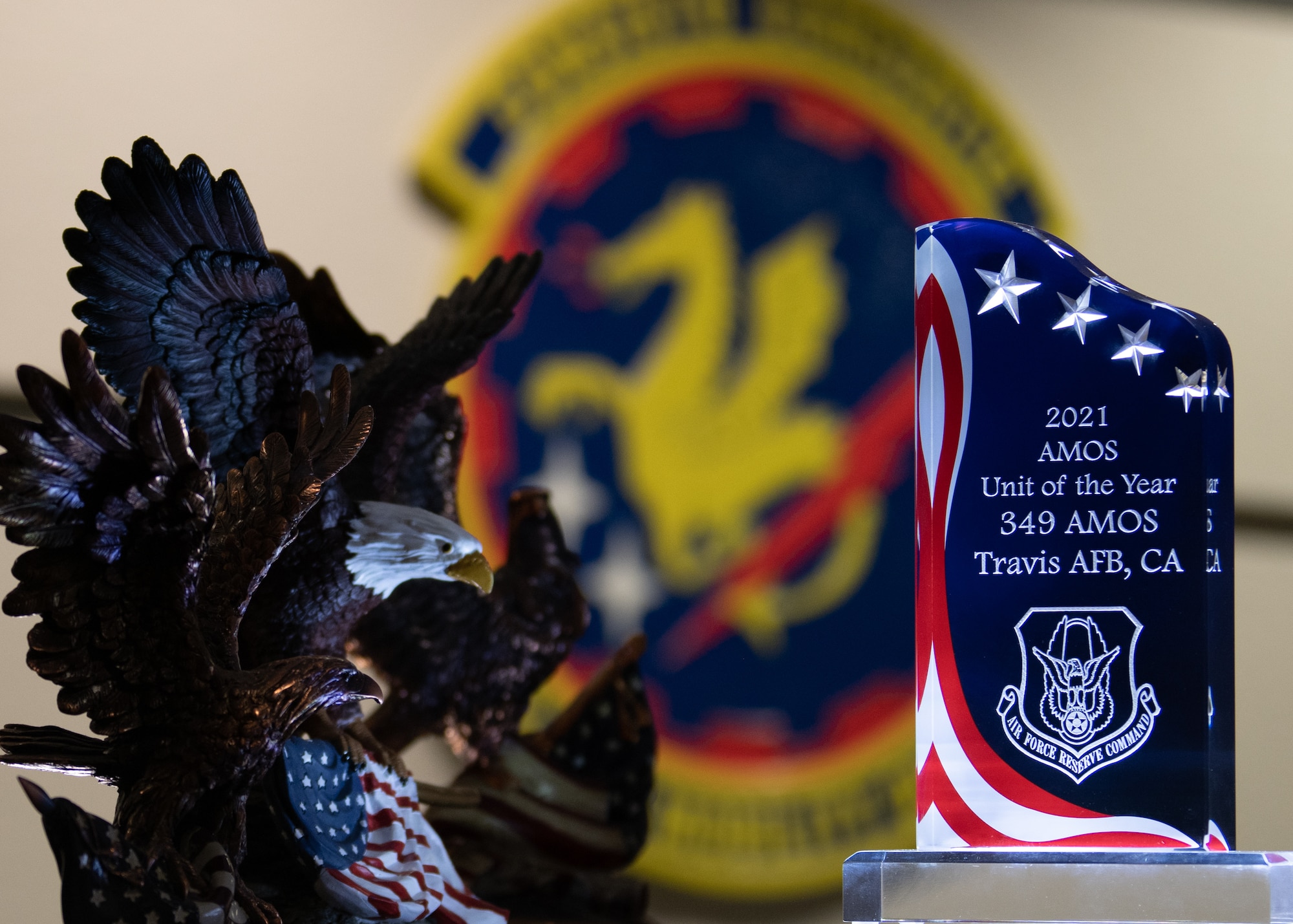 The 349th Air Mobility Operations Squadron was named the Air Force Reserve Command AMOS unit of the year for the fifth time in 2021.  Also in the photo are trophies of the same honor from previous years. (U.S. Air Force photo by Master Sgt. Jose B. Aquilizan)