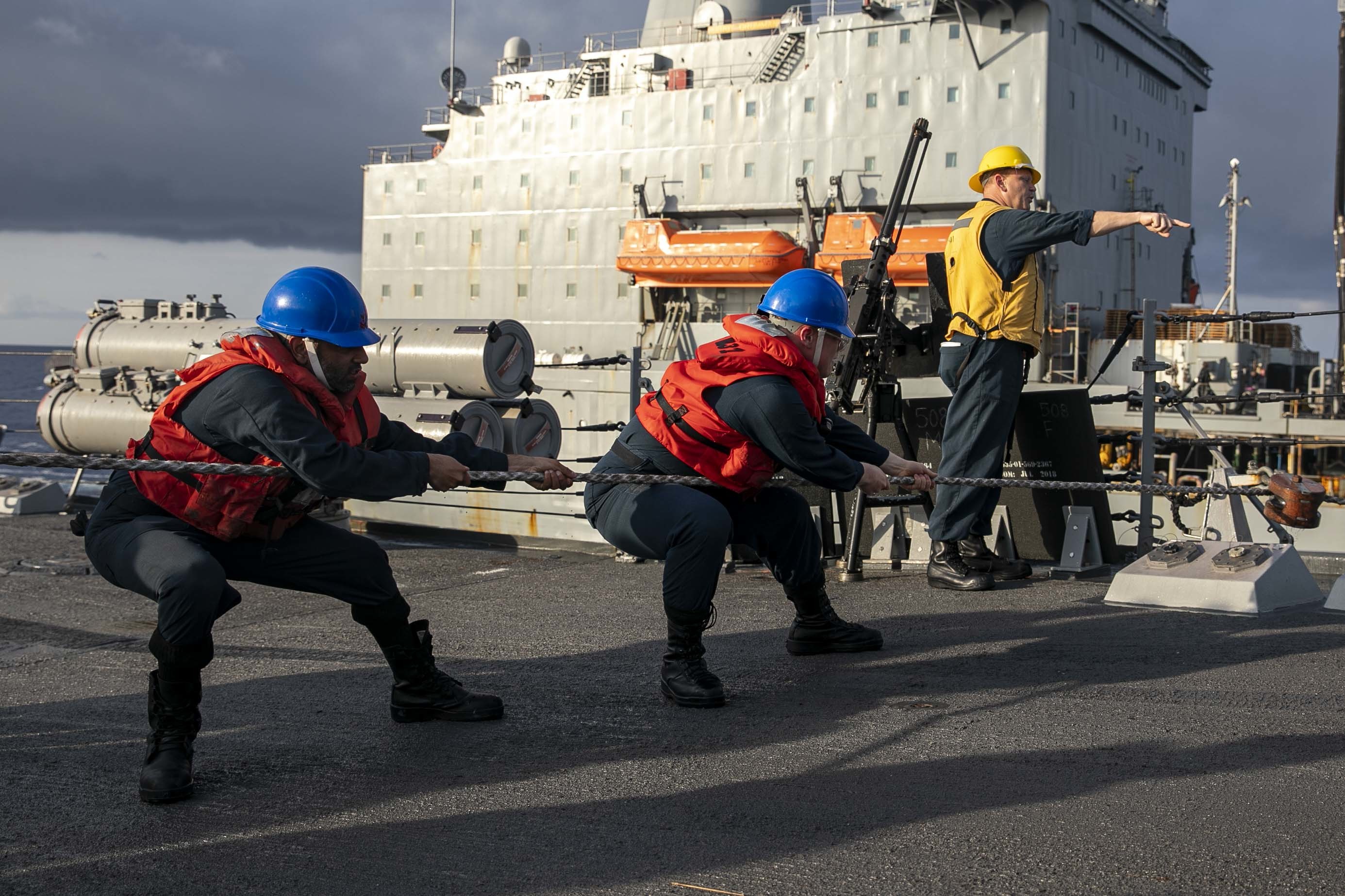 Sailors assigned to the Arleigh Burke-class guided-missile destroyer USS Delbert D. Black (DDG 119) handle a line during a replenishment-at-sea with fleet replenishment oiler USNS Leroy Grumman (T-AO 195), June 25, 2022.