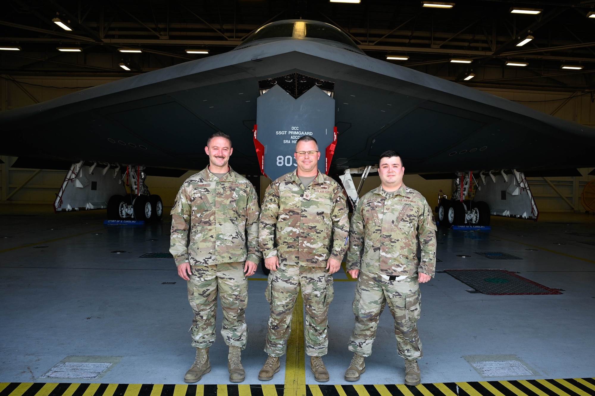 Airmen assigned to Whiteman Air Force Base stand for a photo to represent those who have received Spirit numbers at Whiteman AFB, Missouri, June 30, 2022. A Spirit number is a sequential number that is assigned only to a person who has flown in the B-2 Spirit Stealth Bomber which not only includes pilots but cabinet-level secretaries, senior military leaders, members of Congress and award winning enlisted military members. (U.S Air Force Photo by Senior Airman Christina Carter)