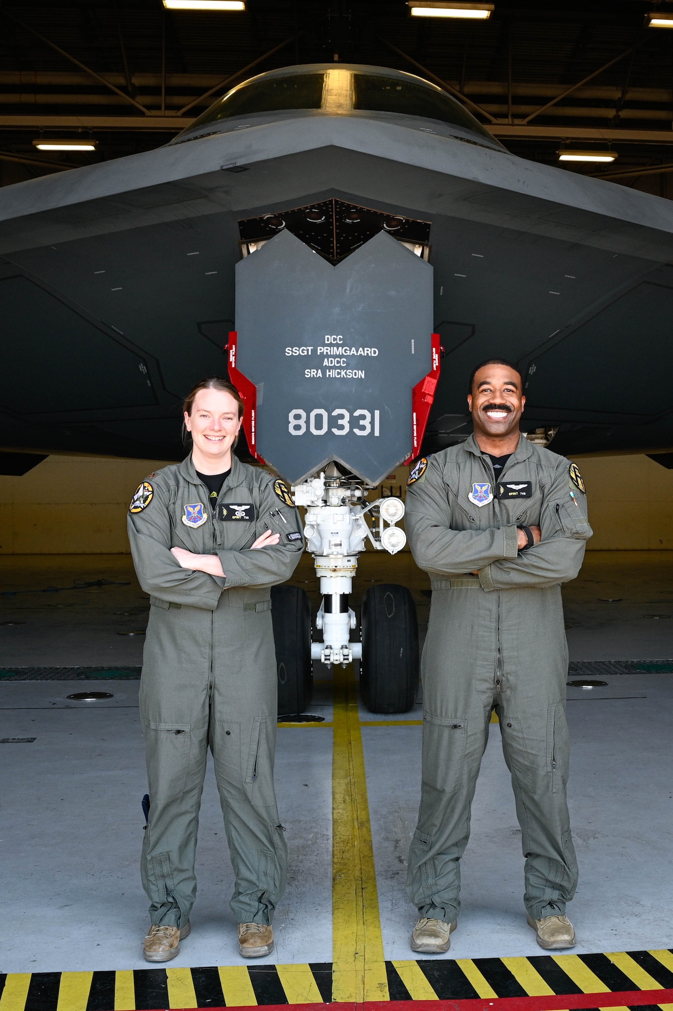 Two U.S. Air Force B-2 Spirit pilots stand for a photo to represent those who have received Spirit numbers at Whiteman Air Force Base, Missouri, June 30, 2022. A Spirit number is a sequential number that is assigned only to a person  who has flown in the B-2 Spirit Stealth Bomber.(U.S Air Force Photo by Senior Airman Christina Carter)