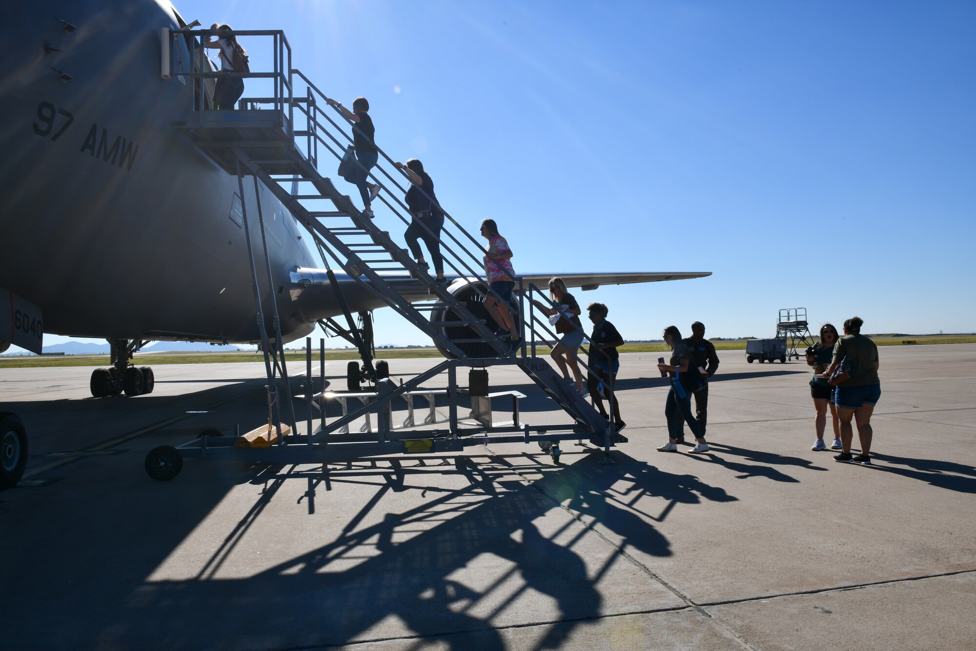 Spouses of 97th Air Mobility Wing Airmen board a KC-46 Pegasus at Altus Air Force Base (AAFB), Oklahoma, July 11, 2022. The KC-46 is one of two aerial refueling aircraft at AAFB, the other being the KC-135 Stratotanker. (U.S. Air Force photo by Airman 1st Class Miyah Gray)