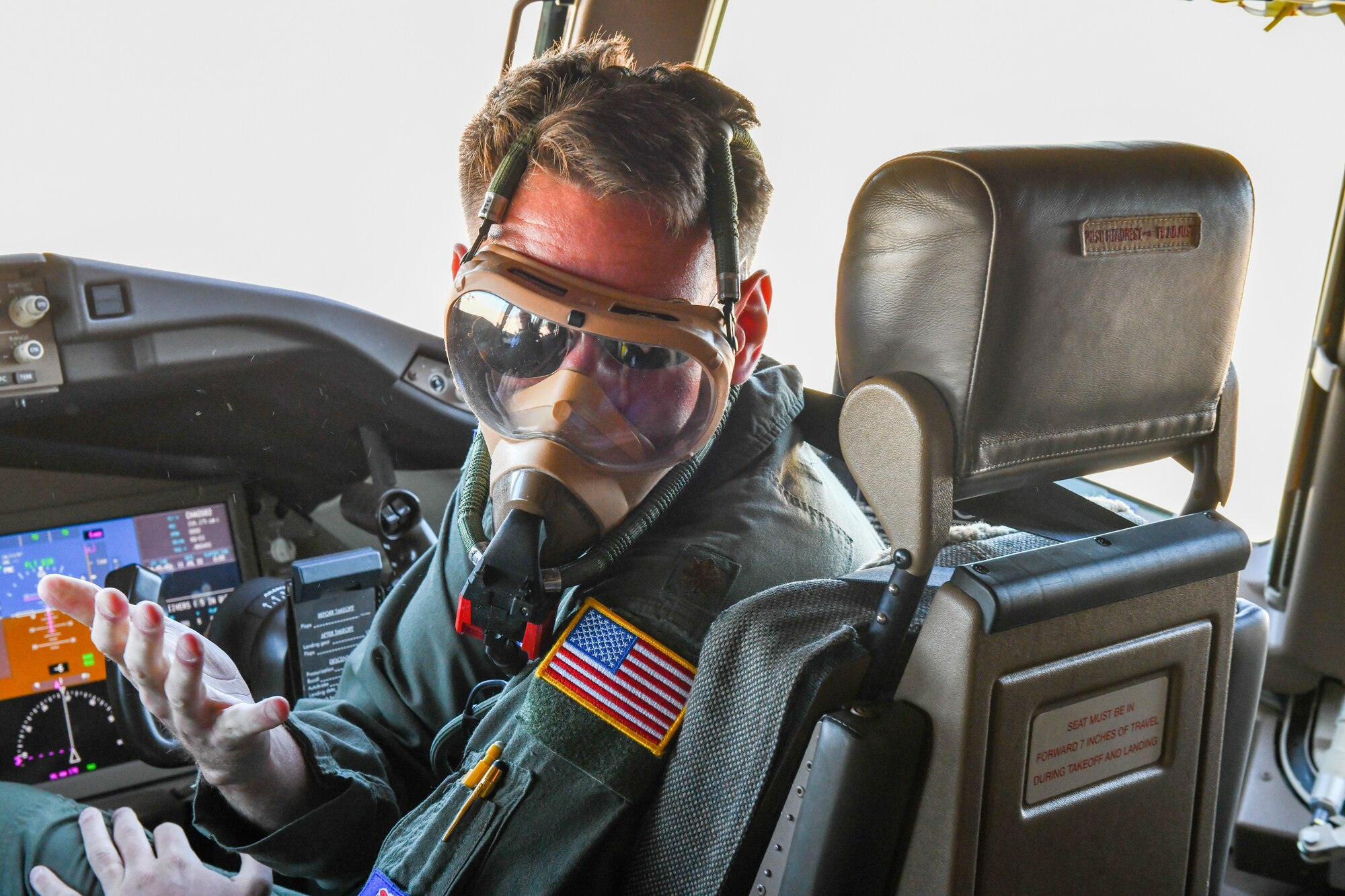 U.S. Air Force Maj. Matthew Schaefer, 56th Air Refueling Squadron instructor pilot, demonstrates proper wear of an oxygen mask at Altus Air Force Base, Oklahoma, July 11, 2022. Oxygen masks prevent hypoxia if the cabin pressure drops. (U.S. Air Force photo by Airman 1st Class Miyah Gray)
