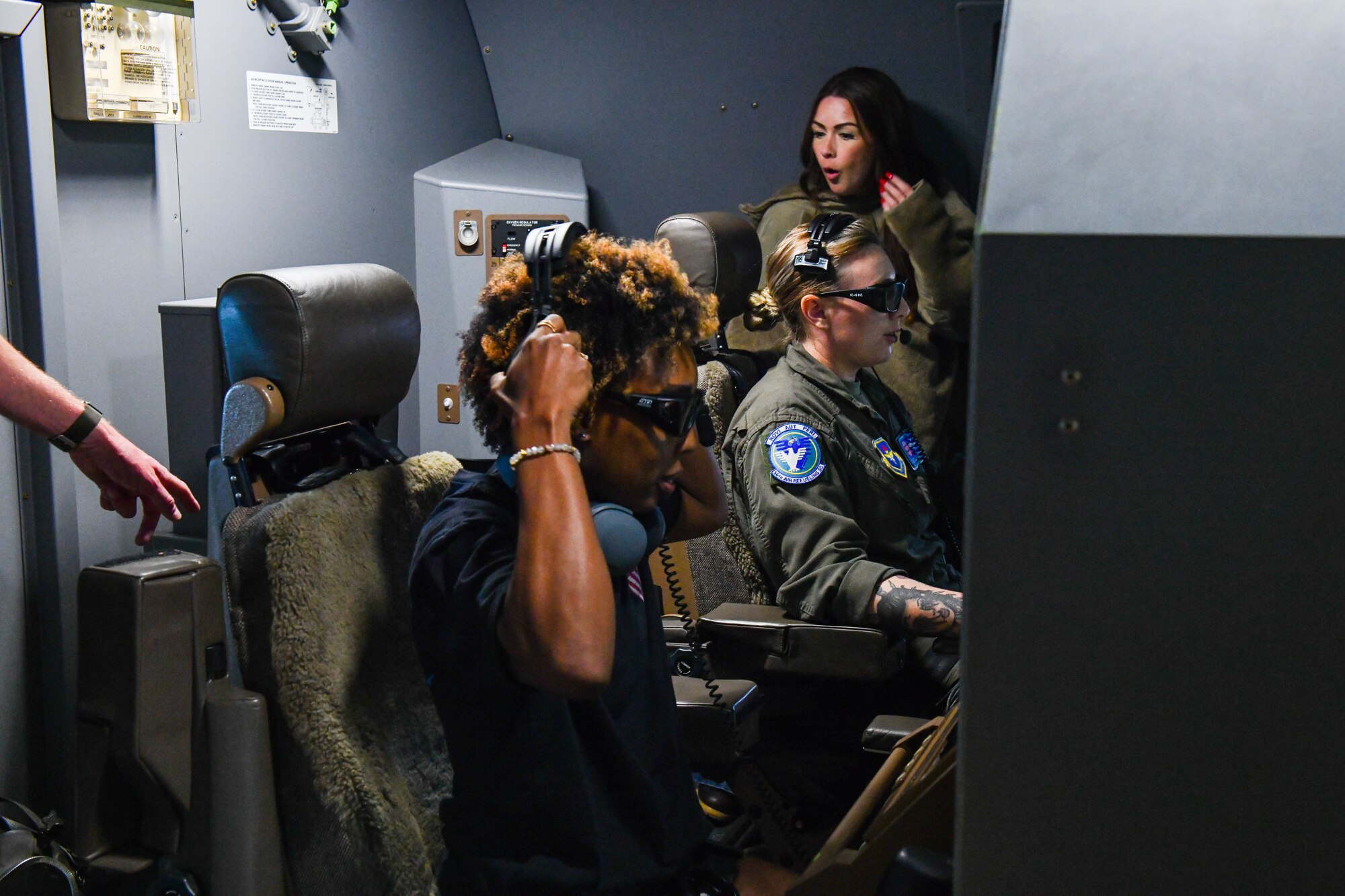 Shaneka Vondohlen, spouse of Senior Master Sgt. Joseph Vondohlen, dons a headset on a KC-46 Pegasus at Altus Air Force Base, Oklahoma, July 11, 2022. The headsets are used to reduce noise and facilitate clear communication. (U.S. Air Force photo by Airman 1st Class Miyah Gray)