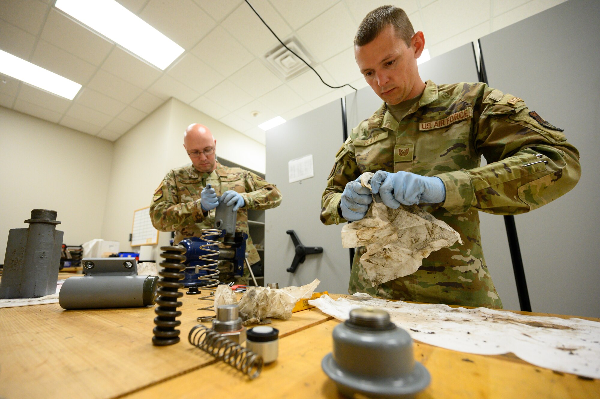 A photo of Airmen repairing a tow bar