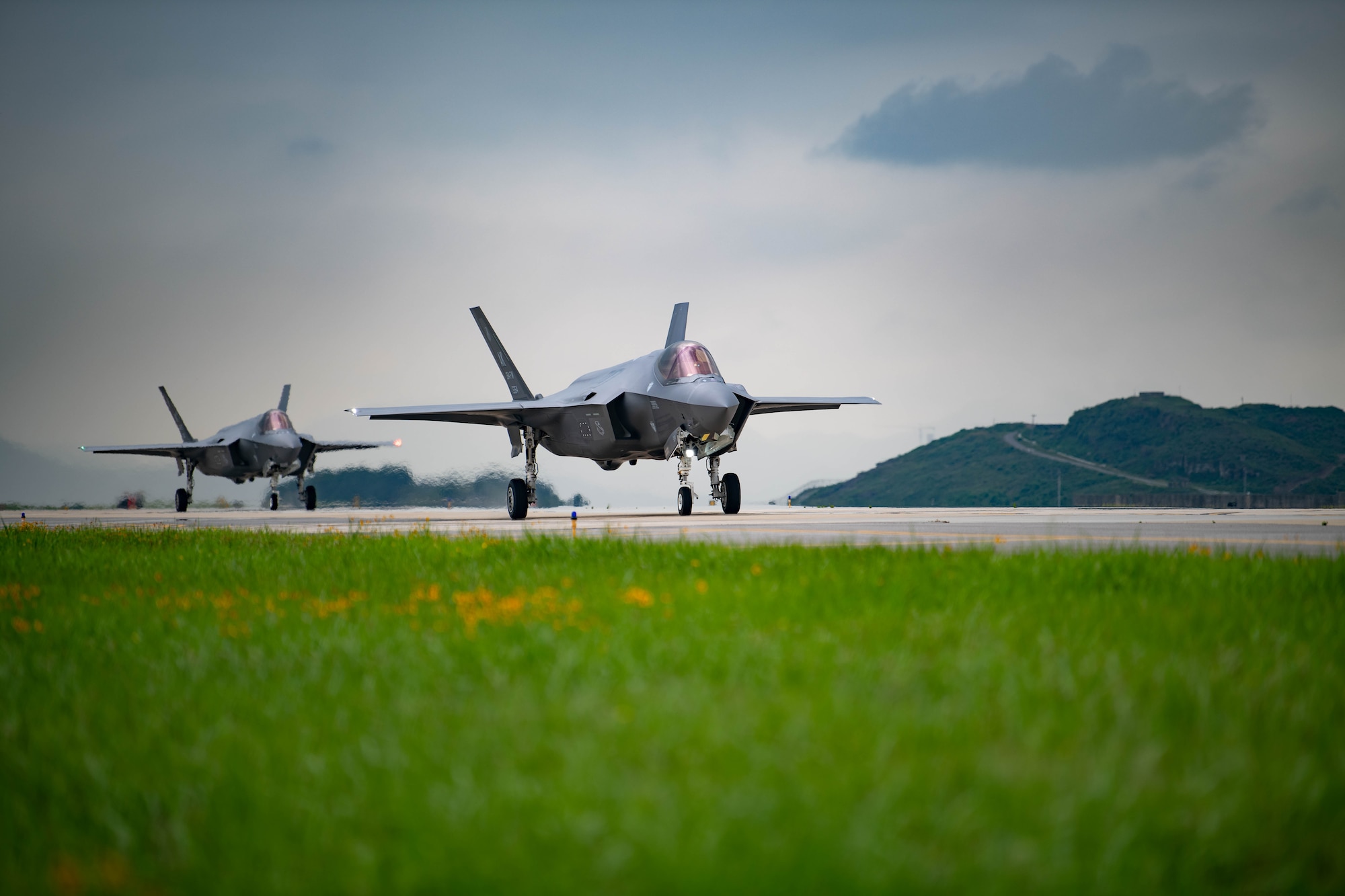 Two F-35A Lightning II’s taxi down a runway at Kunsan Air Base, Republic of Korea, July 11, 2022.U.S. Air Force F-35 aircraft from Eielson Air Force Base, Alaska arrived in the Republic of Korea to conduct training flights with ROKAF to enhance interoperability between the two Air Forces on and
around the Korean Peninsula. (U.S. Air Force photo by Senior Airman Shannon Braaten)