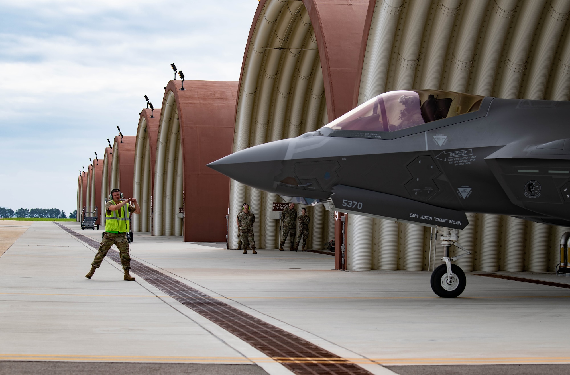 Senior Airman Thomas Trail, 354th Aircraft Maintenance Squadron maintainer, signals an F-35A Lightning II pilot at Kunsan Air Base, Republic of Korea, July 5, 2022. U.S. Air Force F-35 aircraft from Eielson Air Force Base, Alaska arrived in the Republic of Korea to conduct training flights with ROKAF
to enhance interoperability between the two Air Forces on and around the Korean Peninsula. (U.S. Air Force photo by Senior Airman Shannon Braaten)