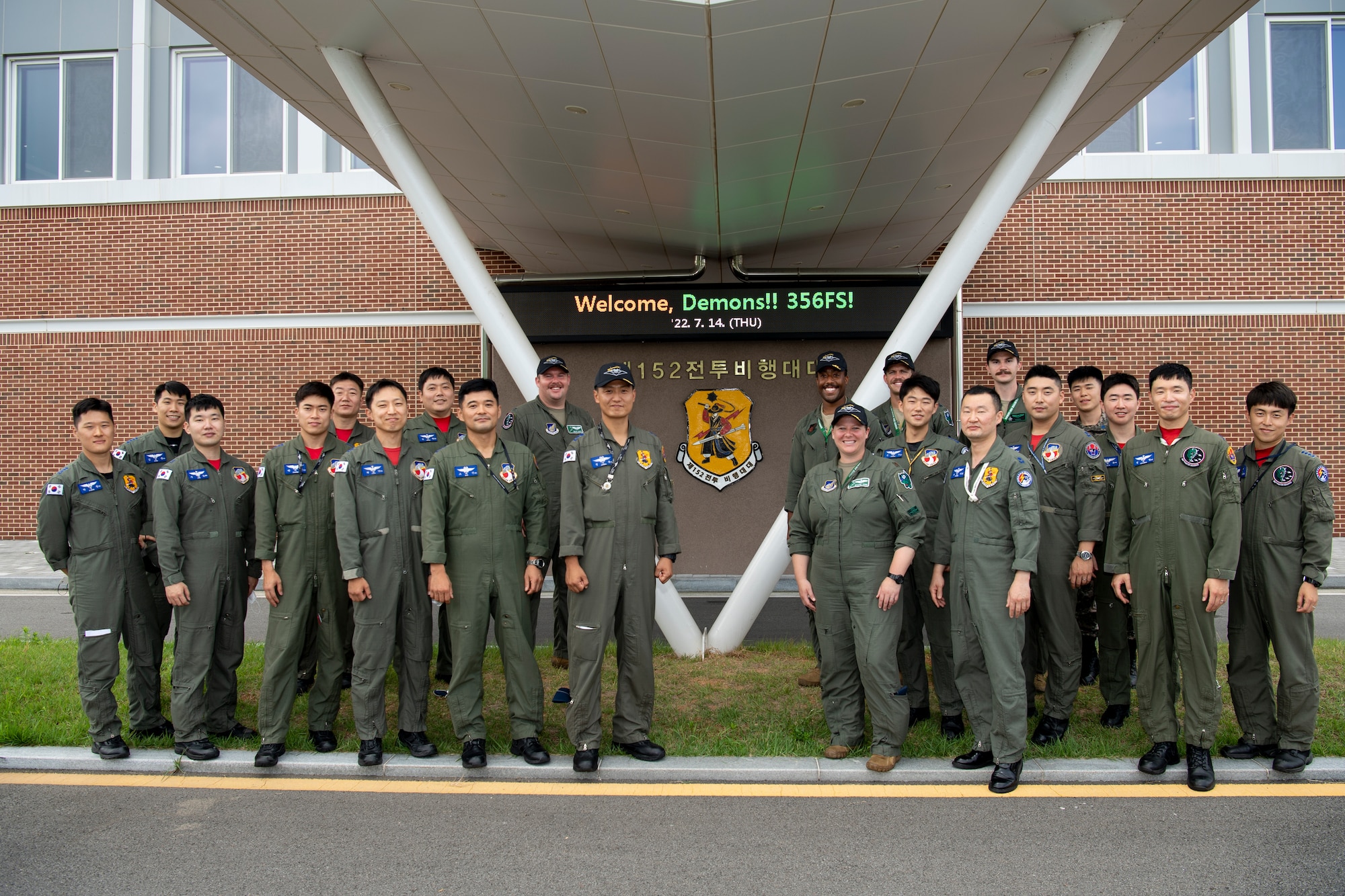 Republic of Korea Air Force (ROKAF) F-35 pilots from the 152nd Fighter Squadron, stand in front of their squadron building with U.S. Air Force (USAF) F-35 pilots assigned to the 356th Fighter Squadron from Eielson Air Force Base, Alaska, at Cheonju Air Base, Republic of Korea, July 14, 2022. Over the past week, F-35 pilots from the ROKAF and USAF flew together increasing their knowledge of each other’s tactics and procedures, while also strengthening the ROK-U.S. alliance. (U.S. Air Force photo by Master Sgt. Kenneth W. Norman)