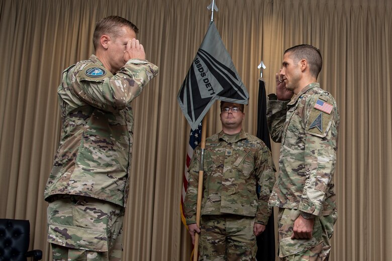 Two military men in uniform saluting each other
