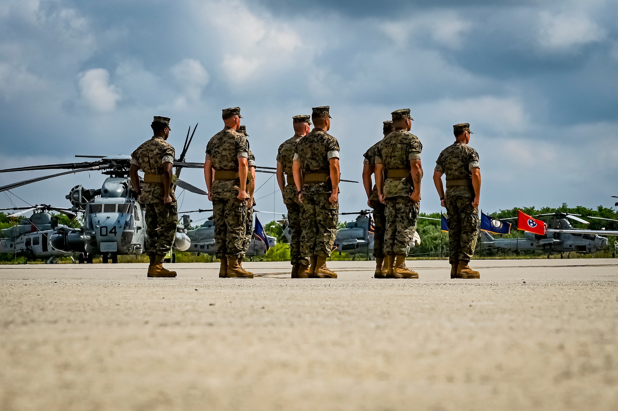 U.S. Marine Corps. Officers assigned to Marine Aircraft Group 49 stand at attention as part of a change of command ceremony on July 16, 2022 at Joint Base McGuire Dix Lakehurst. The change of command ceremony is a military tradition that represents a formal transfer of authority and responsibility for a unit from one officer to another. The mission of MAG 49 is to organize, train, and equip combat ready squadrons to augment and reinforce the active Marine forces in time of war, national emergency, or contingency operations, and to provide personnel and assault support capabilities to relieve operational tempo for active duty forces. (U.S. Air Force Photo by Senior Airman Matt Porter)