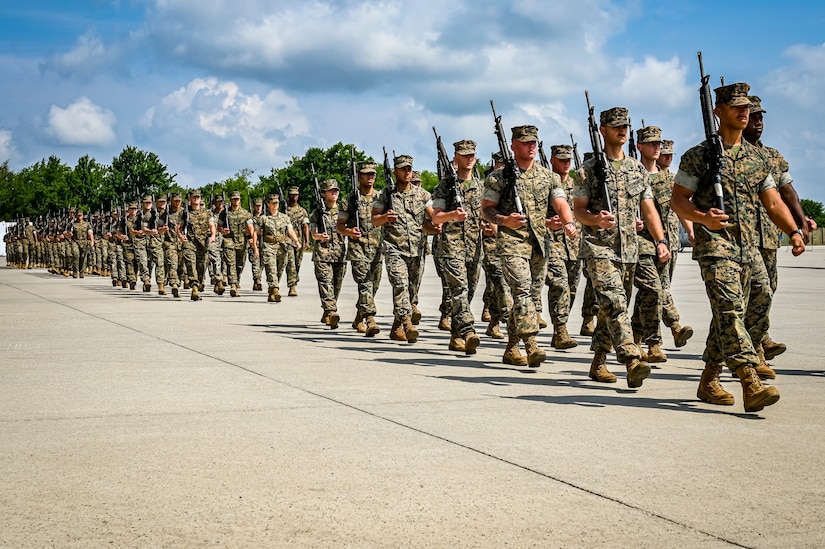 U.S. Marines assigned to Marine Aircraft Group 49 parade march as part of a change of command ceremony on July 16, 2022 at Joint Base McGuire Dix Lakehurst. The change of command ceremony is a military tradition that represents a formal transfer of authority and responsibility for a unit from one officer to another. The mission of MAG 49 is to organize, train, and equip combat ready squadrons to augment and reinforce the active Marine forces in time of war, national emergency, or contingency operations, and to provide personnel and assault support capabilities to relieve operational tempo for active duty forces. (U.S. Air Force Photo by Senior Airman Matt Porter)