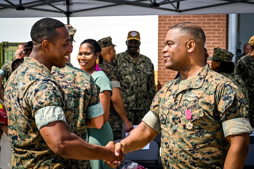 A U.S. Marine assigned to Marine Aircraft Group 49 shakes the hand of U.S. Marine Corps. Col. Lonnie Cobb following a change of command ceremony on July 16, 2022 at Joint Base McGuire Dix Lakehurst. The change of command ceremony is a military tradition that represents a formal transfer of authority and responsibility for a unit from one officer to another. The mission of MAG 49 is to organize, train, and equip combat ready squadrons to augment and reinforce the active Marine forces in time of war, national emergency, or contingency operations, and to provide personnel and assault support capabilities to relieve operational tempo for active duty forces. (U.S. Air Force Photo by Senior Airman Matt Porter)