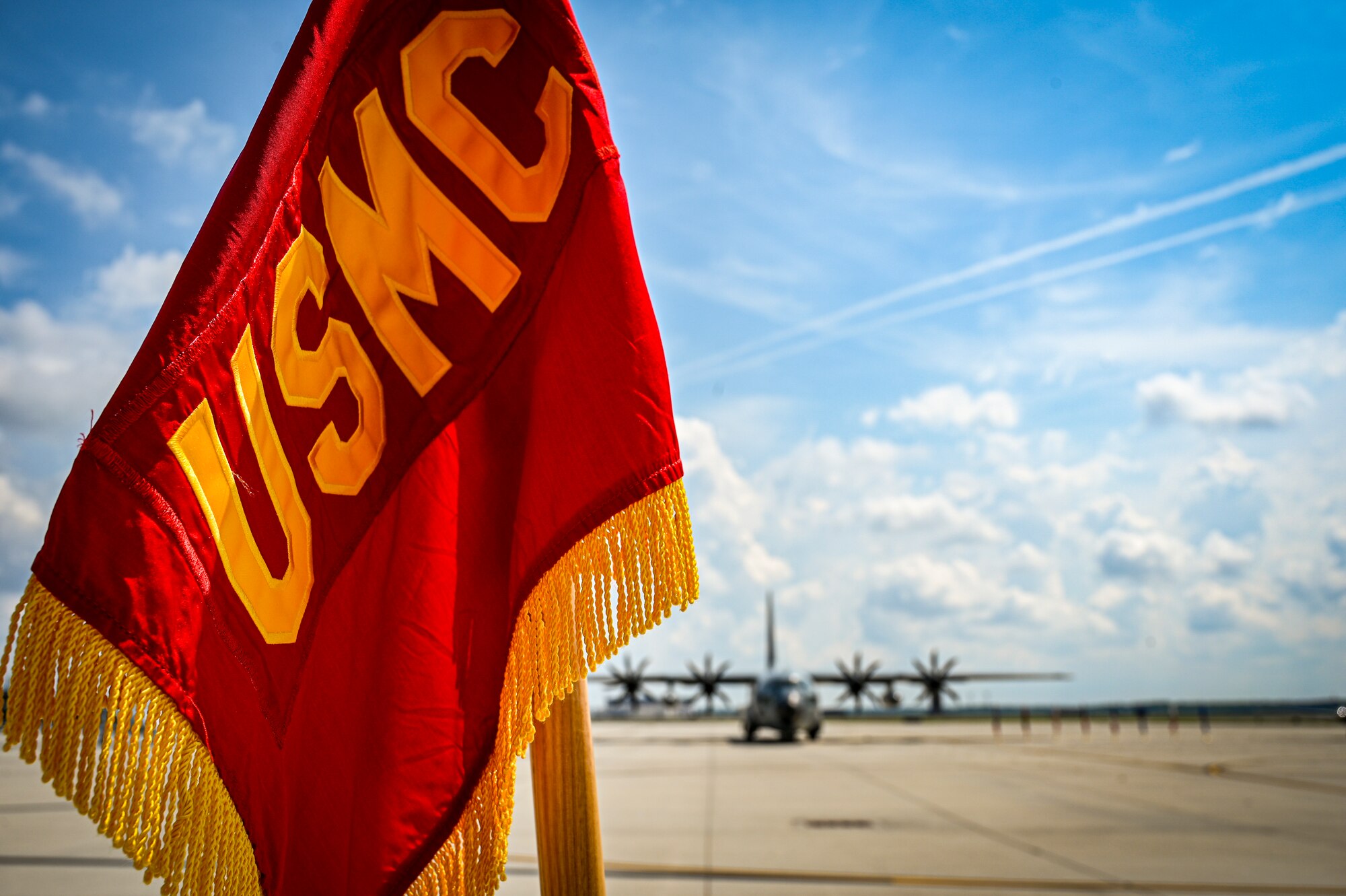 A flag embroidered with U.S. Marine Corps. is displayed as part of a change of command ceremony for Marine Aircraft Group 49 on July 16, 2022 at Joint Base McGuire Dix Lakehurst. The change of command ceremony is a military tradition that represents a formal transfer of authority and responsibility for a unit from one officer to another. The mission of MAG 49 is to organize, train, and equip combat ready squadrons to augment and reinforce the active Marine forces in time of war, national emergency, or contingency operations, and to provide personnel and assault support capabilities to relieve operational tempo for active duty forces. (U.S. Air Force Photo by Senior Airman Matt Porter)