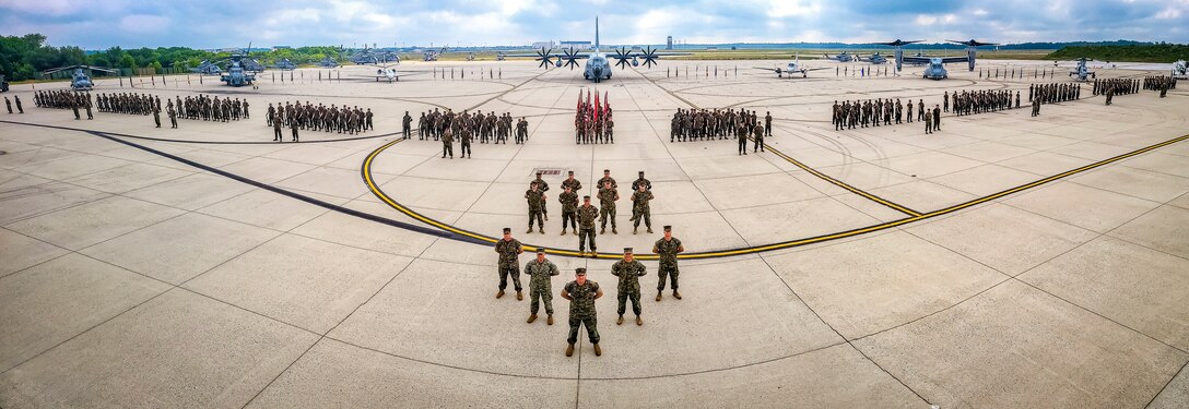 U.S. Marines assigned to Marine Aircraft Group 49 pose for a group photo on July 16, 2022 at Joint Base McGuire Dix Lakehurst. The mission of MAG 49 is to organize, train, and equip combat ready squadrons to augment and reinforce the active Marine forces in time of war, national emergency, or contingency operations, and to provide personnel and assault support capabilities to relieve operational tempo for active duty forces. (U.S. Air Force Photo by Senior Airman Matt Porter)