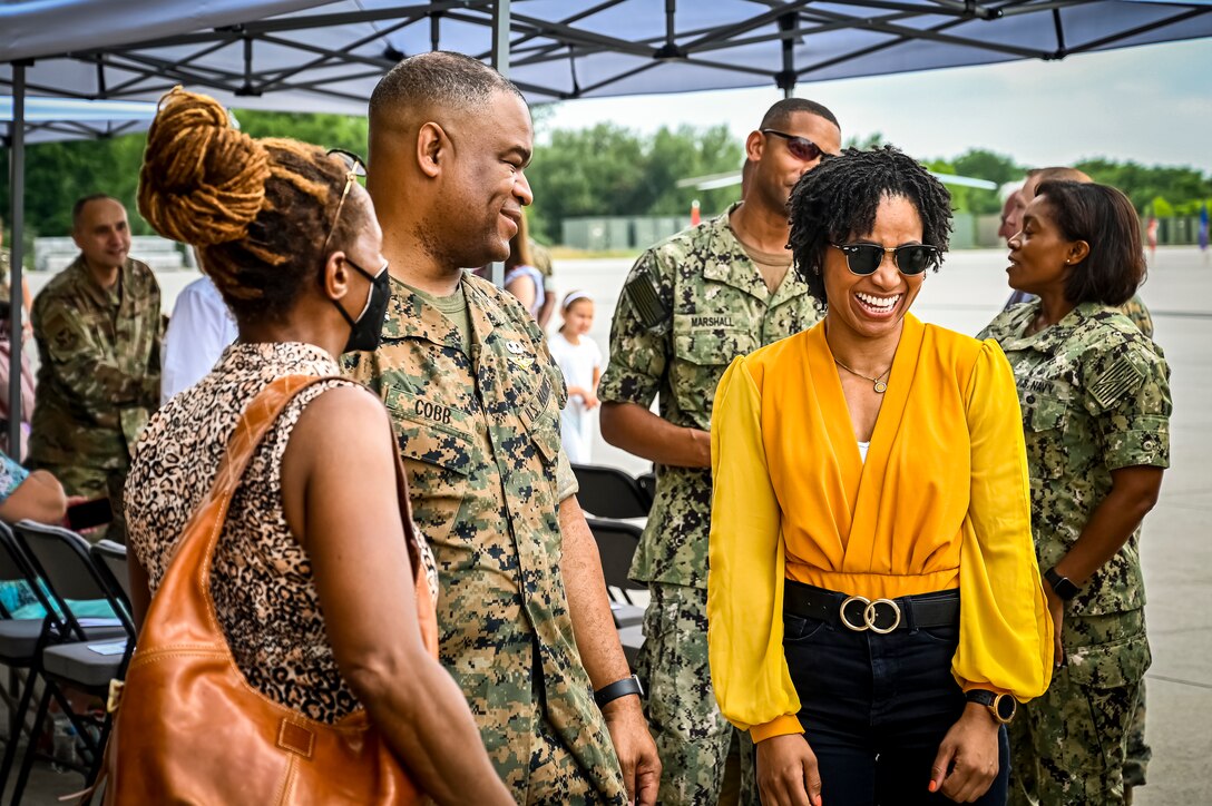 U.S. Marine Corps. Col. Lonnie Cobb, Marine Aircraft Group 49 commander, visits with guests before a change of command ceremony on July 16, 2022 at Joint Base McGuire Dix Lakehurst. The change of command ceremony is a military tradition that represents a formal transfer of authority and responsibility for a unit from one officer to another. The mission of MAG 49 is to organize, train, and equip combat ready squadrons to augment and reinforce the active Marine forces in time of war, national emergency, or contingency operations, and to provide personnel and assault support capabilities to relieve operational tempo for active duty forces. (U.S. Air Force Photo by Senior Airman Matt Porter)