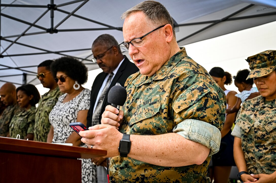 U.S. Navy Cmrd. John Brown, Marine Aircraft Group 49 chaplain, gives the invocation for a change of command ceremony on July 16, 2022 at Joint Base McGuire Dix Lakehurst. The change of command ceremony is a military tradition that represents a formal transfer of authority and responsibility for a unit from one officer to another. The mission of MAG 49 is to organize, train, and equip combat ready squadrons to augment and reinforce the active Marine forces in time of war, national emergency, or contingency operations, and to provide personnel and assault support capabilities to relieve operational tempo for active duty forces. (U.S. Air Force Photo by Senior Airman Matt Porter)