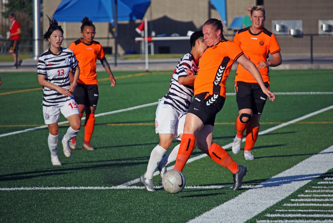 Netherlands Rivke Draaijea pushes past defenders in match 12 of the 13th Conseil International du Sport Militaire (CISM) World Women's Military Football Championship hosted by Fairchild Air Force Base in Spokane, Washingon.  This year's championship features teams from the United States, Belgium, Cameroon, Canada, France, Germany, Ireland, Mali, Netherlands, and South Korea.  (Department of Defense Photo by Mr. Steven Dinote, released).