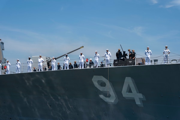 Sailors assigned to the Arleigh Burke-class guided-missile destroyer USS Nitze (DDG 94), man the rails as Nitze deploys from Naval Station Norfolk, July 17.