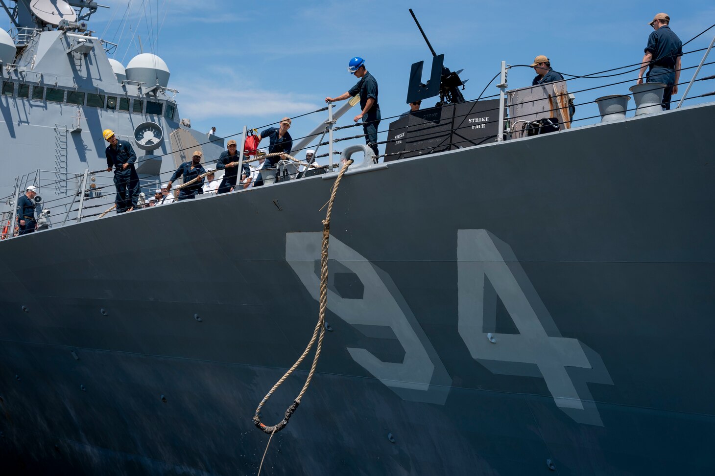 Sailors assigned to the Arleigh Burke-class guided-missile destroyer USS Nitze (DDG 94), haul in the mooring lines as Nitze deploys from Naval Station Norfolk, July 17.