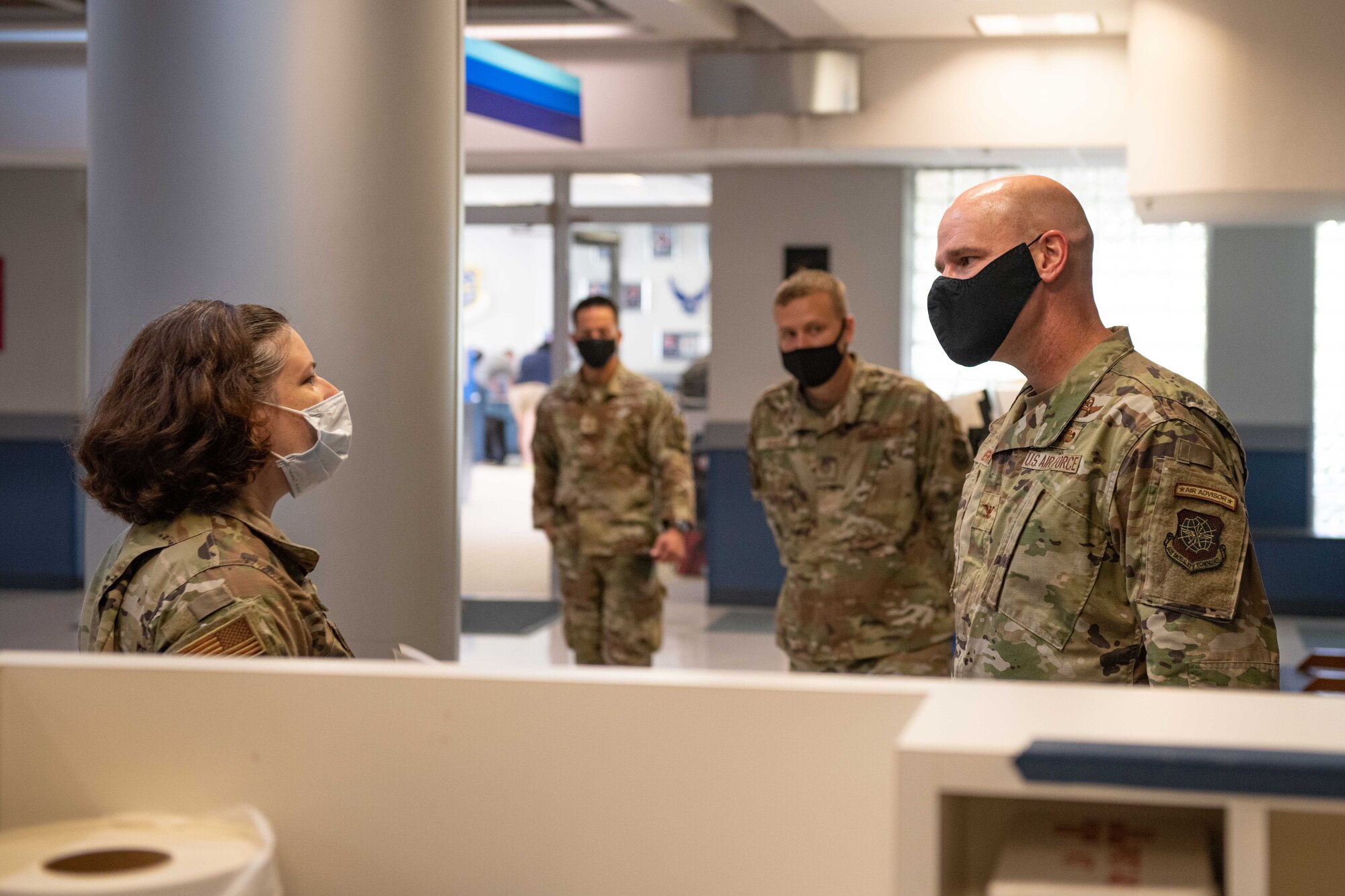 A commander receives a tour of a terminal from an Airman