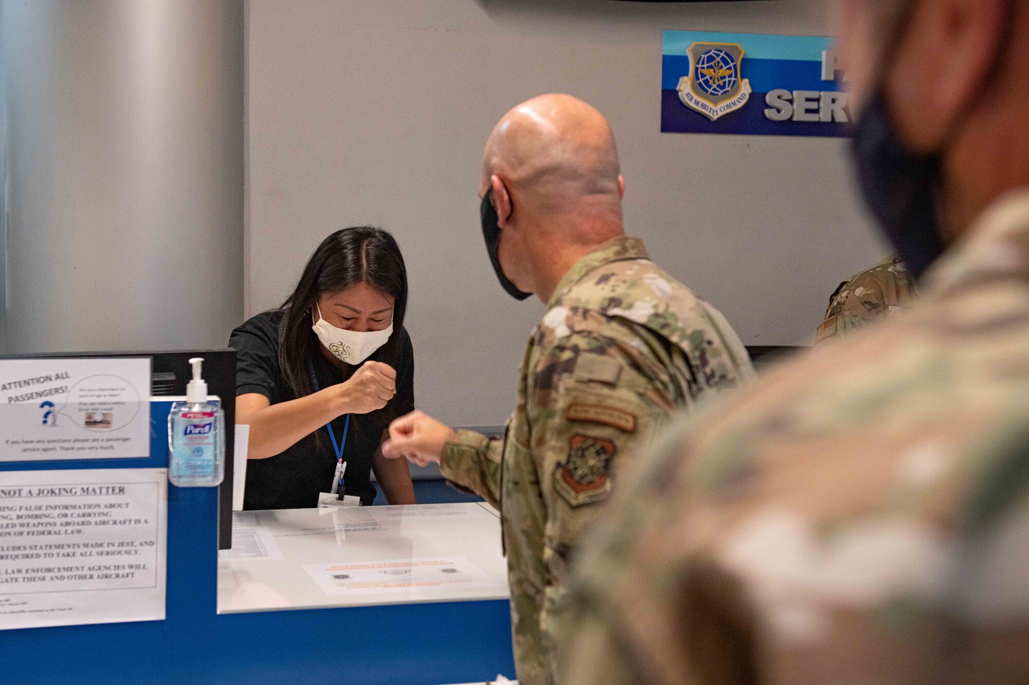 A commander greets a civilian worker