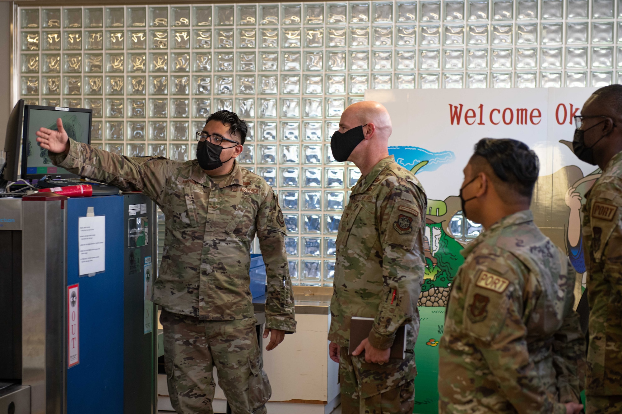 An Airman shows a commander how a machine works