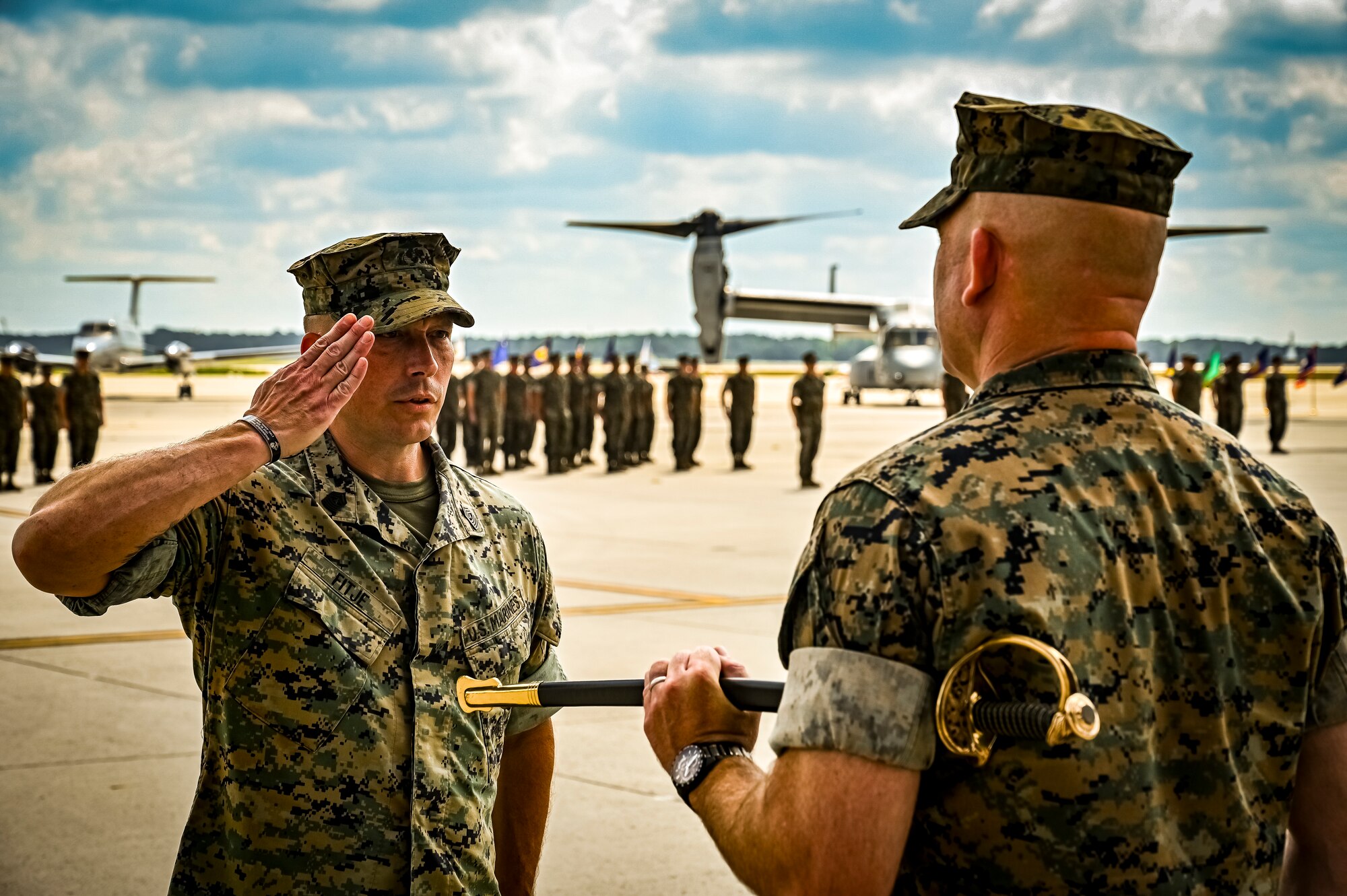 U.S. Marine Corps. Sg. Maj. Dorma Fitje, Marine Aircraft Group 49 sergeant major, renders a salute to U.S. Marine Corps. Col. Russell Rybka, Marine Aircraft Group 49 commander, during a relief and appointment retirement ceremony on July 17, 2022 at Joint Base McGuire Dix Lakehurst, N.J. The relief and appointment is a military tradition that represents a formal transfer of authority and responsibility for a unit from one senior noncommissioned officer to another. The mission of MAG 49 is to organize, train, and equip combat ready squadrons to augment and reinforce the active Marine forces in time of war, national emergency, or contingency operations, and to provide personnel and assault support capabilities to relieve operational tempo for active duty forces. (U.S. Air Force Photo by Senior Airman Matt Porter)