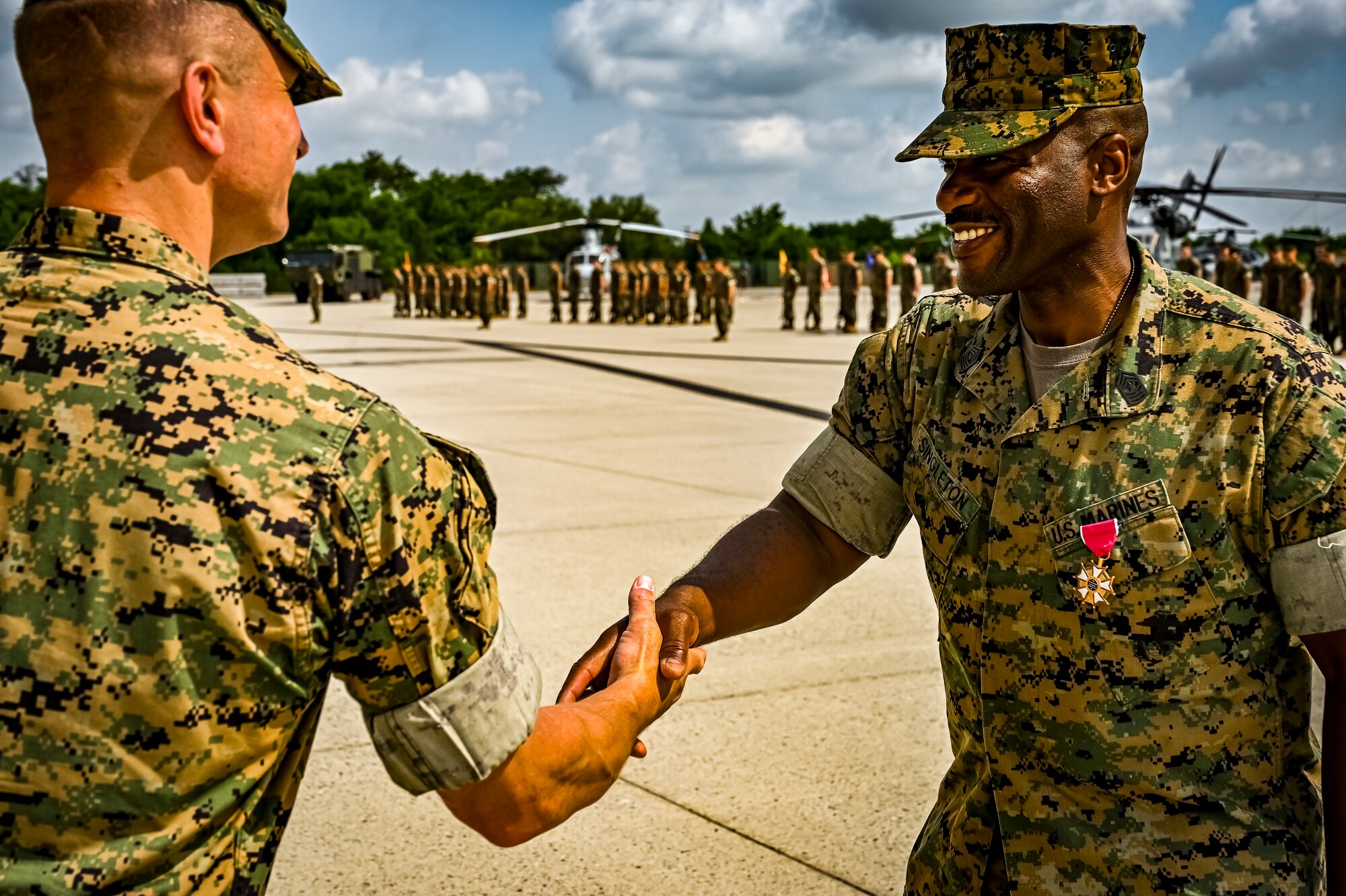 U.S. Marine Corps. Sg. Maj. William Singleton, Marine Aircraft Group 49 sergeant major, receives the Legion of Merit award from U.S. Marine Corps. Col. Stuart Smith Jr., during a relief and appointment retirement ceremony on July 17, 2022 at Joint Base McGuire Dix Lakehurst, N.J. The relief and appointment is a military tradition that represents a formal transfer of authority and responsibility for a unit from one senior noncommissioned officer to another. The mission of MAG 49 is to organize, train, and equip combat ready squadrons to augment and reinforce the active Marine forces in time of war, national emergency, or contingency operations, and to provide personnel and assault support capabilities to relieve operational tempo for active duty forces. (U.S. Air Force Photo by Senior Airman Matt Porter)