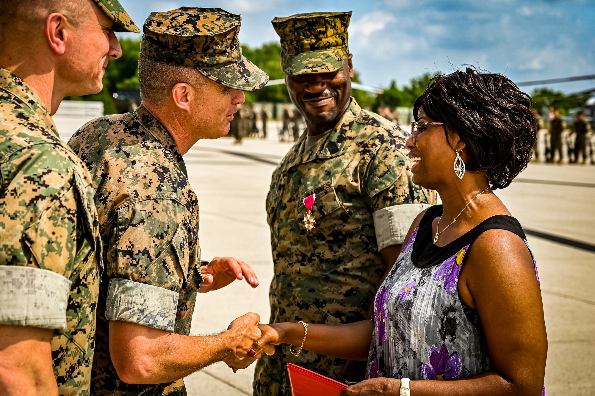 U.S. Marine Corps. Sg. Maj. William Singleton, Marine Aircraft Group 49 sergeant major, and spouse, receives an award of appreciation from U.S. Marine Corps. Col. Stuart Smith Jr., during a relief and appointment retirement ceremony on July 17, 2022 at Joint Base McGuire Dix Lakehurst, N.J. The relief and appointment is a military tradition that represents a formal transfer of authority and responsibility for a unit from one senior noncommissioned officer to another. The mission of MAG 49 is to organize, train, and equip combat ready squadrons to augment and reinforce the active Marine forces in time of war, national emergency, or contingency operations, and to provide personnel and assault support capabilities to relieve operational tempo for active duty forces. (U.S. Air Force Photo by Senior Airman Matt Porter)