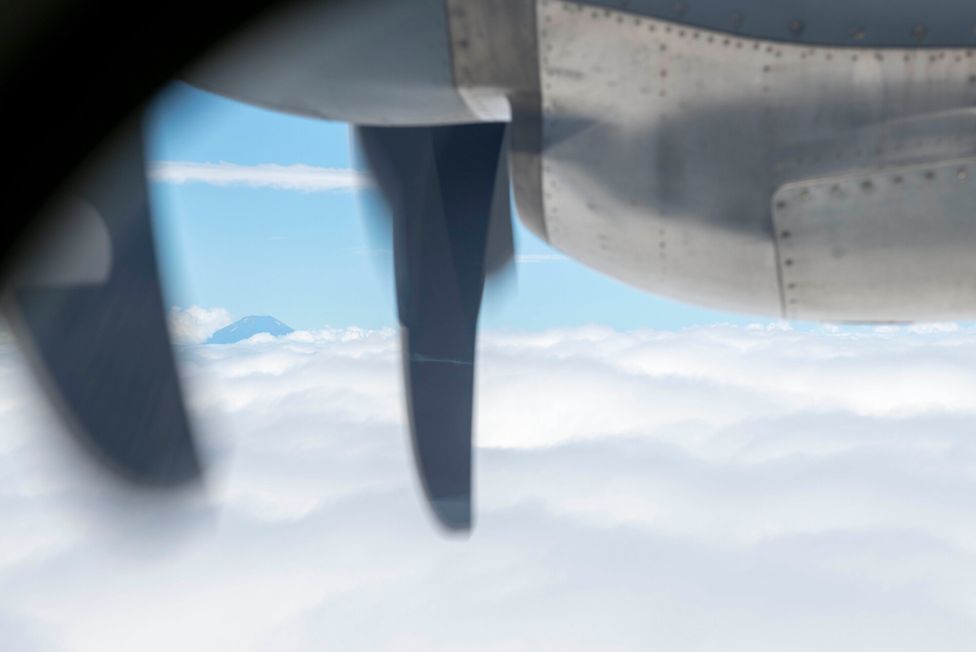 A C-130J Super Hercules flies by Mt. Fuji