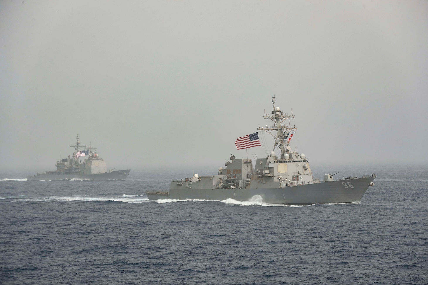 The Nimitz-class aircraft carrier USS Abraham Lincoln (CVN 72) sails alongside the Arleigh Burke-class guided-missile destroyer USS Bainbridge (DDG 96) and the Ticonderoga-class guided-missile cruiser USS Mobile Bay (CG 53) during a photo exercise. The Abraham Lincoln and John C. Stennis carrier strike groups are conducting carrier strike force operations in the U.S. 6th Fleet. Together, the strike groups will complete high-end warfighting training, enhancing interoperability with key allies and partners in the European theater.