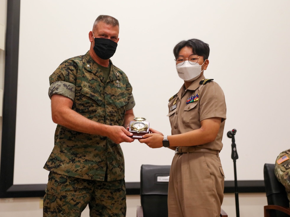 Marine Col. Kipp Wahlgren Deputy Commander, U.S. Marine Corps Forces Korea presents award to Korea midshipmen from the Republic of Korea Naval Academy.