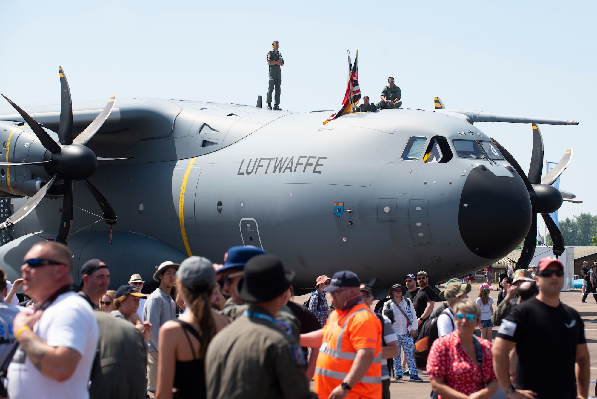 Airshow attendees walk by an aircraft