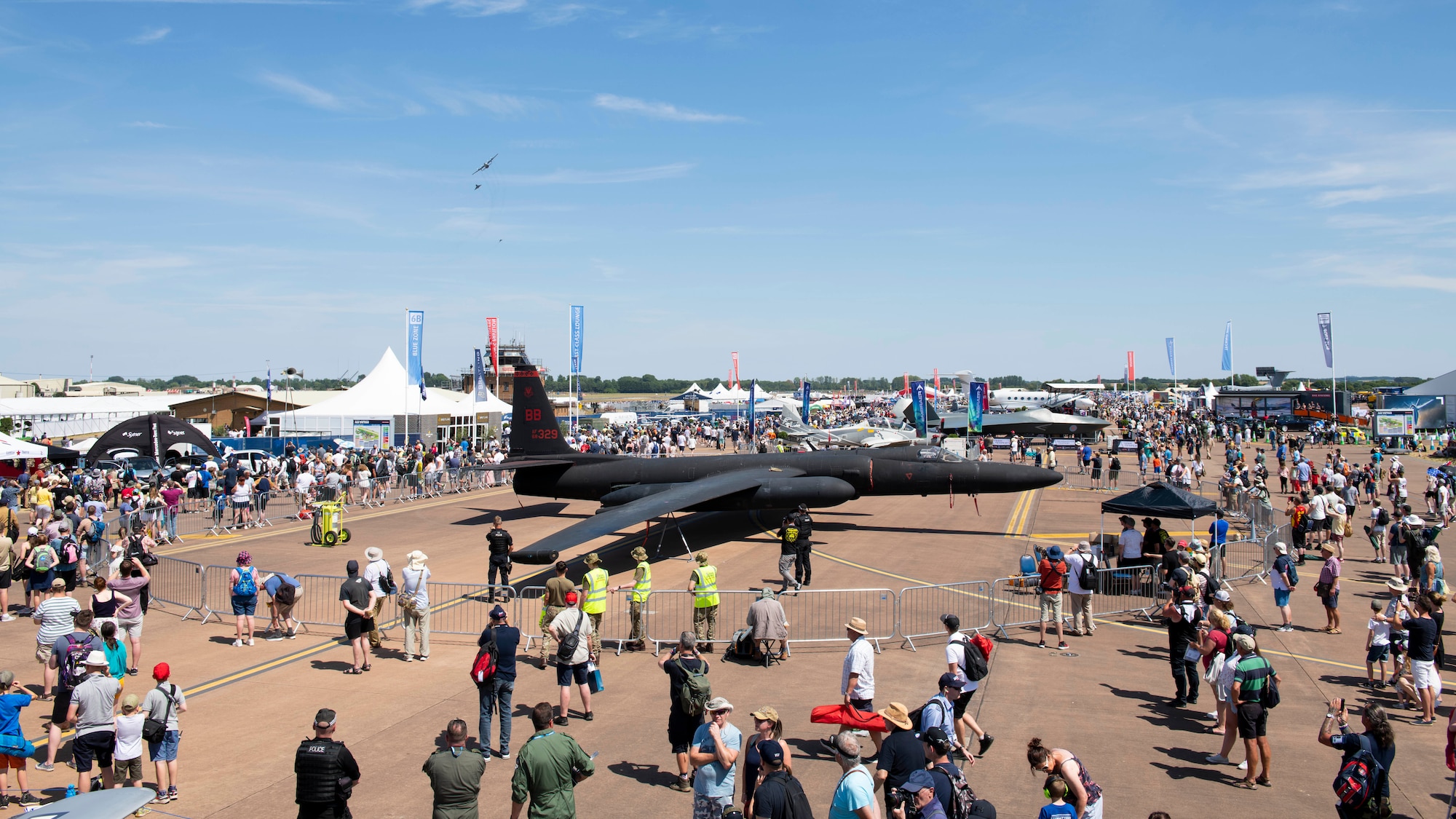 Attendees walk though an airshow