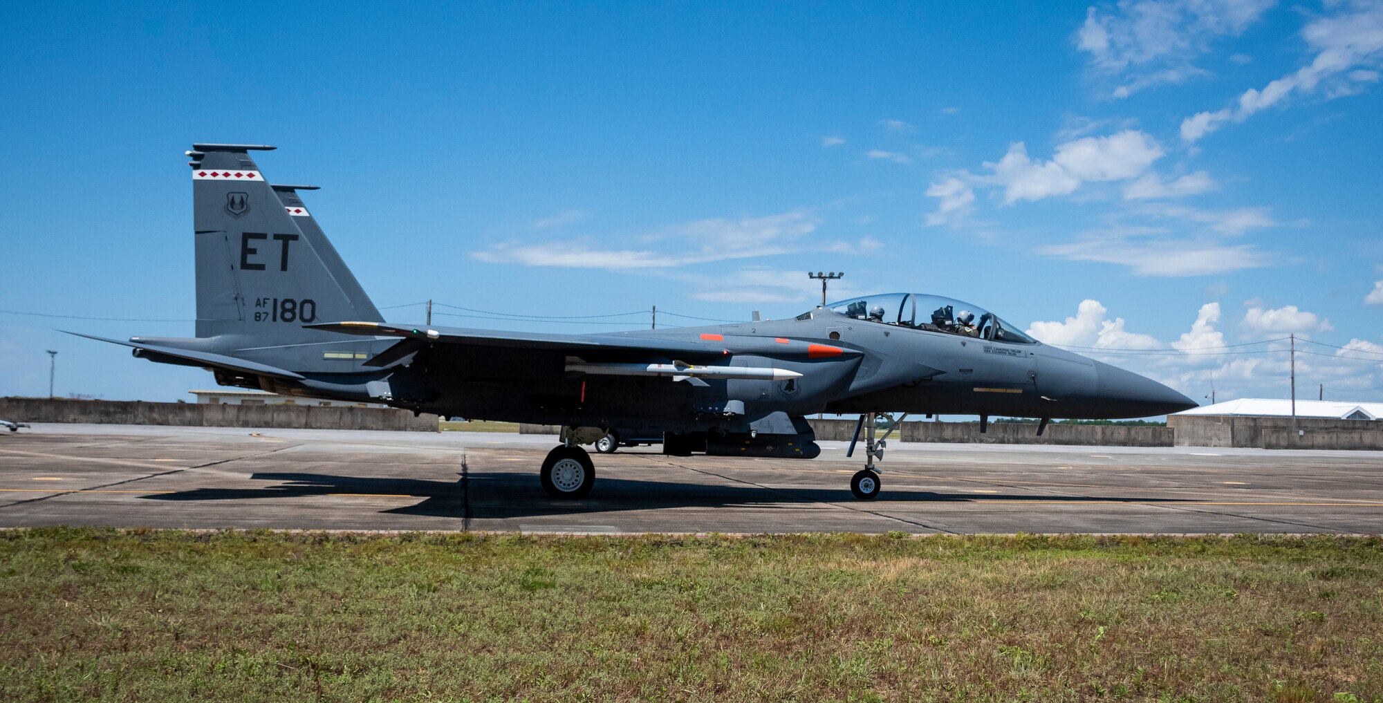 An F-15E Strike Eagle taxis in preparation for a live-fire mission where the crew will launch an AIM-120D3 using production missile hardware developed under the AMRAAM Form, Fit, Function Refresh program. Executed by the 28th Test and Evaluation Squadron and 85th TES, the core objective of the test was to execute a long-range shot that physically stressed the new missile hardware and verified no changes to the missile kinematic or target intercept capabilities. (U.S. Air Force photo by 1st Lindsey Heflin)