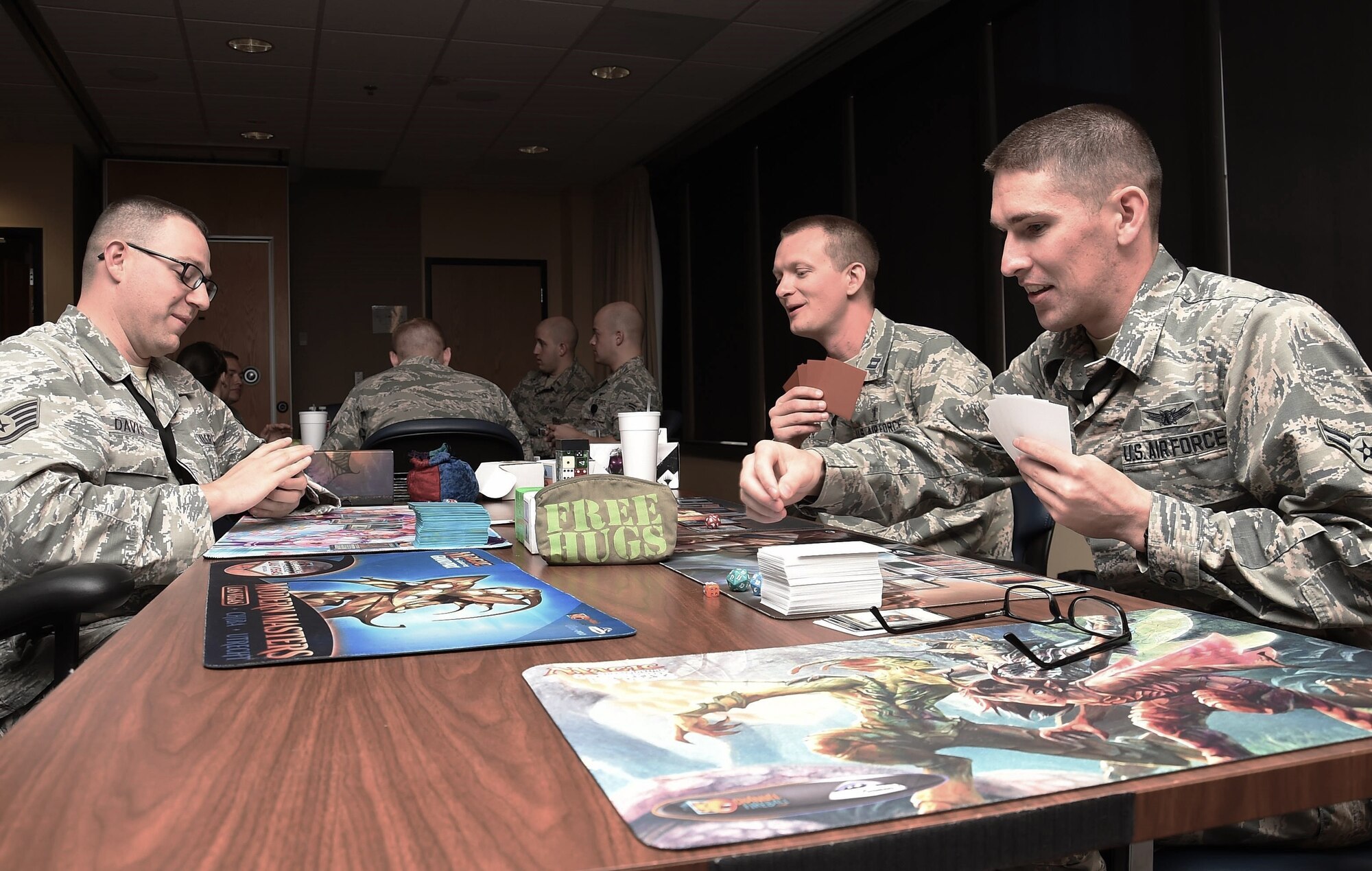 Werner playing a card game with Airmen