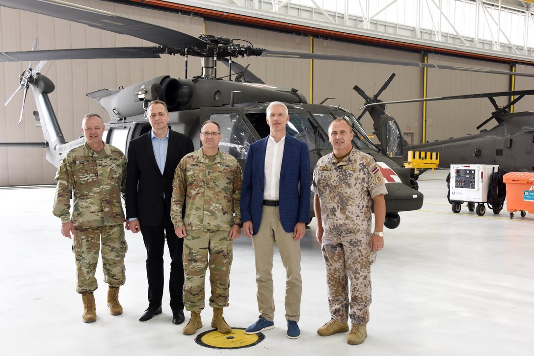 U.S. Army Brig. Gen. Lawrence Schloegl, assistant adjutant general-Army, Latvian Ambassador Māris Selga, U.S. Army Maj. Gen. Paul Rogers, adjutant general and director, Michigan Department of Military and Veterans Affairs, Latvian Prime Minister Krišjānis Kariņš, and Defense Attaché Maj. Gen. Andis Dilāns (left to right) tour the 3rd Battalion, 238th Aviation Regiment aircraft facility, Grand Ledge Armory, Michigan, July 1, 2022. Kariņš visited with Michigan National Guard leadership as his visit took on added significance as the U.S. and Latvia celebrate 100 years of diplomatic relations throughout 2022. For nearly 30 years, the Michigan National Guard has had a rich cooperation with the National Armed Forces of Latvia under the National Guard Bureau’s State Partnership Program. (U.S. Air National Guard photo by Master Sgt. David Eichaker)