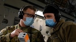 Two military members talking with masks on