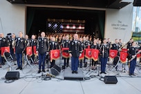 A military band stands at the end of the performance.