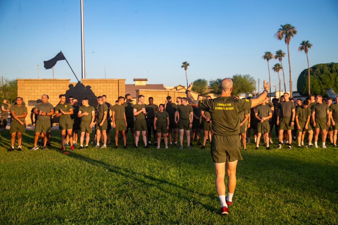 U.S. Marine Corps Gunnery Sgt. Eric Jude, force fitness instructor, Headquarters and Headquarters Squadron, conducts warm-up exercises during a squadron physical training event at Marine Corps Air Station Yuma, Arizona, June 29, 2022.