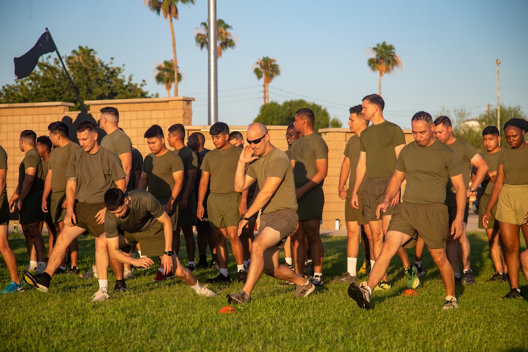 U.S. Marines with Headquarters and Headquarters Squadron, conduct warm-up exercises during a squadron physical training event at Marine Corps Air Station Yuma, Arizona, June 29, 2022.