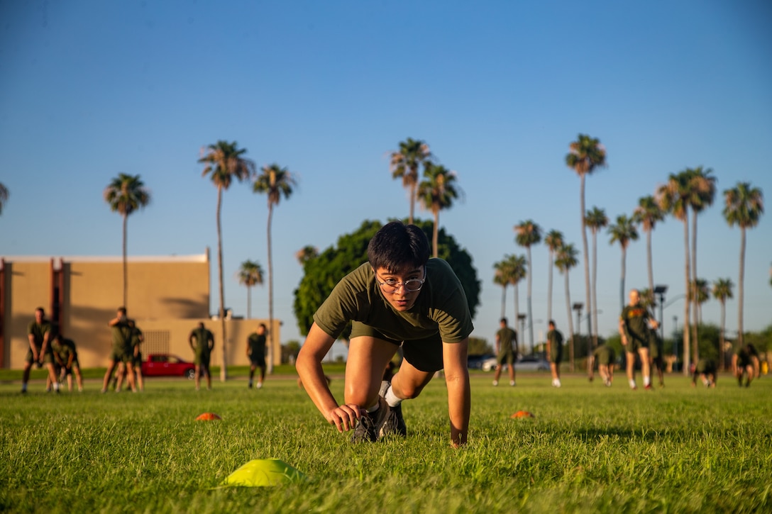 U.S. Marine Corps Lance Cpl. Jade Venegas, combat photographer, Headquarters and Headquarters Squadron, bear crawls during a squadron physical training event at Marine Corps Air Station Yuma, Arizona, June 29, 2022.