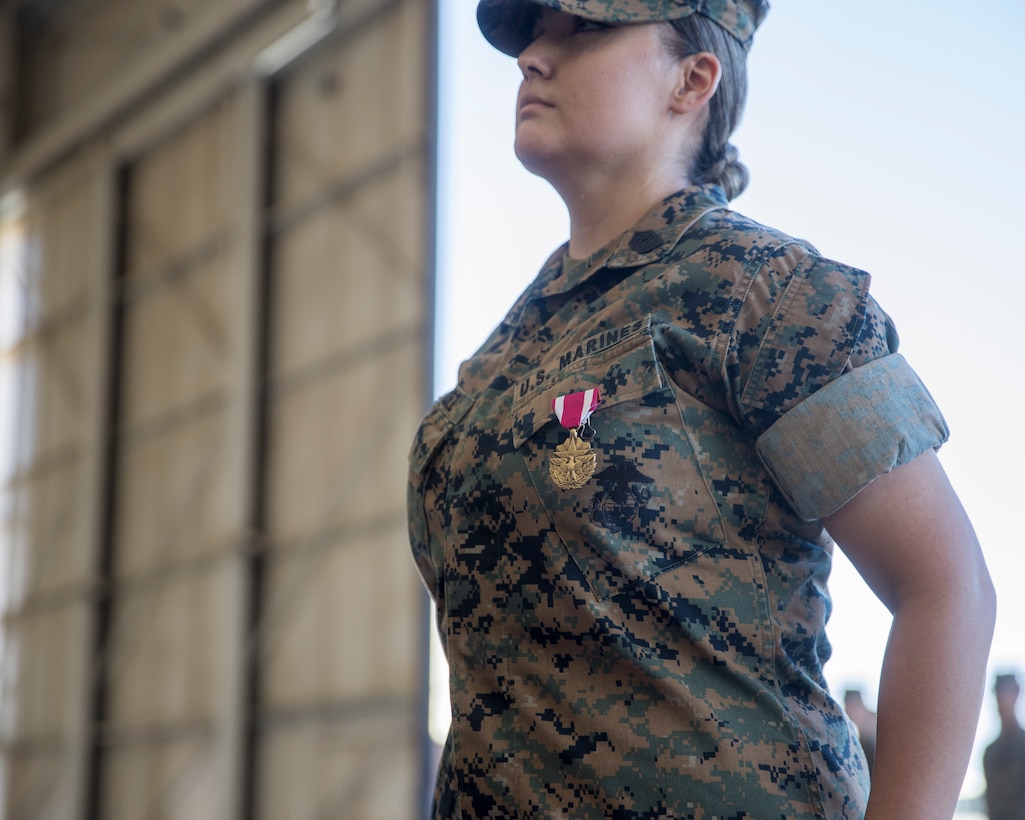U.S. Marine Corps Master Sgt. Maribel Valdez, administrative chief, Marine Aviation Logistics Squadron 13 (MALS-13), 3rd Marine Aircraft Wing, stands at attention after receiving the Meritorious Service Medal during her retirement ceremony at Marine Corps Air Station Yuma, Arizona, June 24, 2022.