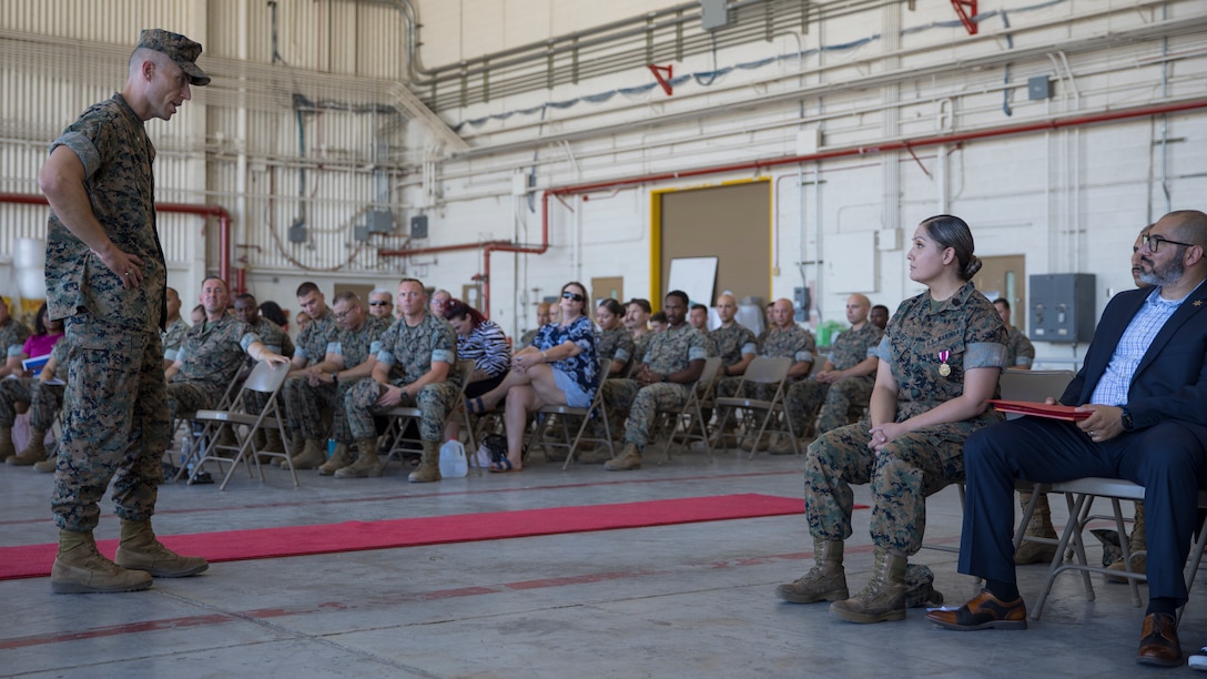 U.S. Marine Corps Lt. Col. William Pomeroy (left), commanding officer, Marine Aviation Logistics Squadron 13 (MALS-13), 3rd Marine Aircraft Wing, speaks to Master Sgt. Maribel Valdez, administrative chief, during her retirement ceremony at Marine Corps Air Station Yuma, Arizona, June 24, 2022.