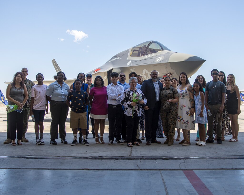 U.S. Marine Corps Master Sgt. Maribel Valdez, administrative chief, Marine Aviation Logistics Squadron 13 (MALS-13), 3rd Marine Aircraft Wing, poses for a photo with family and friends after her retirement ceremony at Marine Corps Air Station Yuma, Arizona, June 24, 2022. Valdez retired after 20 years of service. (U.S. Marine Corps photo by Cpl. Matthew Romonoyske-Bean)
